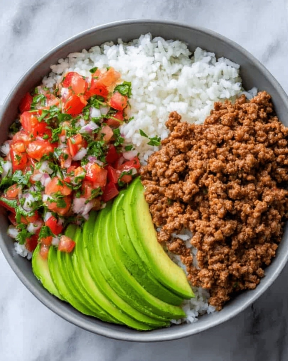 A white bowl filled with three layers of food on a white marbled surface. One layer shows fluffy white rice at the bottom left, topped with a colorful mix of diced red tomatoes, green herbs, and white onions in a fresh salsa-like texture. Next to this is a layer of finely cooked ground meat with a brown, crumbly texture, taking up the top right of the bowl. The last layer, on the left side, has thin slices of bright green avocado arranged carefully in a fan shape. The colors are bright and fresh, with clear separation between each part, photo taken with an iphone --ar 4:5 --v 7