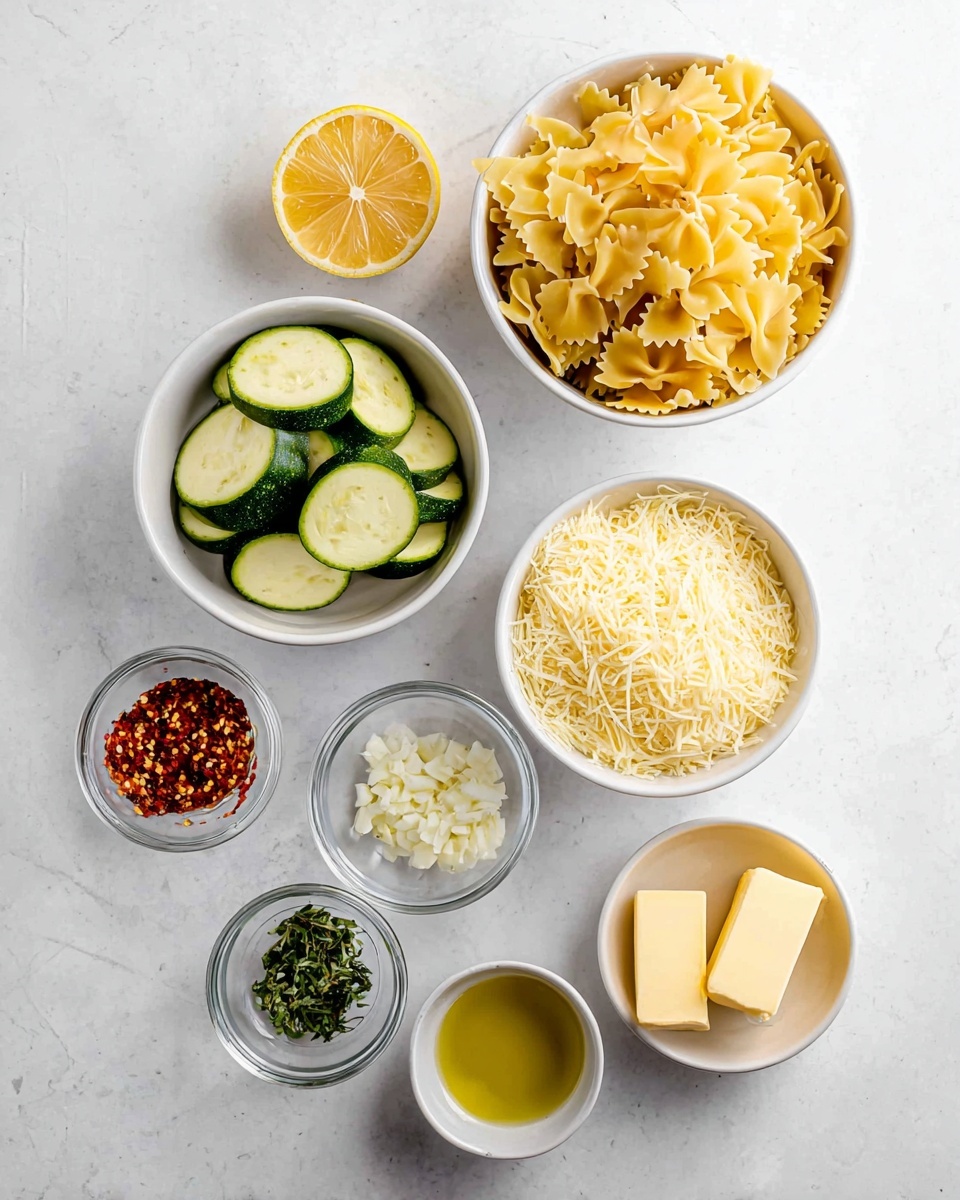 The image shows seven small white bowls placed neatly on a white marbled surface, each holding one ingredient. At the top right, a bowl is filled with dry yellow farfalle pasta. To the left of it, there is half a lemon showing its bright yellow inside. Below that, another bowl contains sliced green zucchini pieces. To the right of the zucchini is a bowl filled with light yellow grated cheese. Below the cheese, a small clear glass bowl holds finely chopped white garlic. To the left of the garlic, a bowl contains red chili flakes and green herbs. Finally, at the bottom right, two small cubes of pale yellow butter sit in a bowl, next to a bowl of golden yellow olive oil. The arrangement is simple and clean, showing fresh, raw ingredients ready for cooking. Photo taken with an iphone --ar 4:5 --v 7