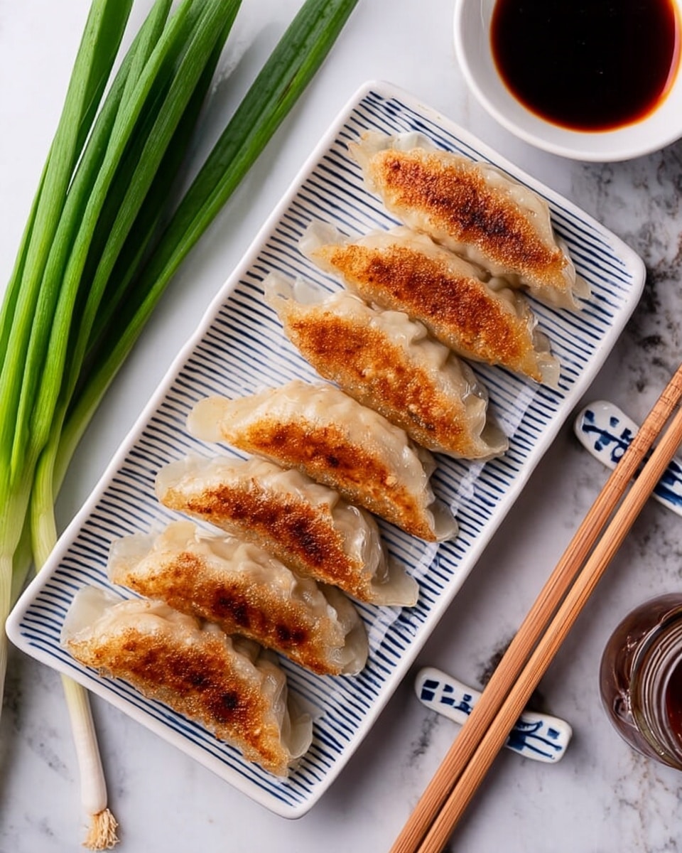 Six pan-fried dumplings with golden-brown crispy tops and light, soft edges are neatly arranged in a row on a white rectangular plate with blue stripes. To the left of the plate, there are fresh green onion stalks resting on a white marbled surface. Above the plate, a small white bowl holds a dark soy dipping sauce. A pair of light wooden chopsticks is placed diagonally on the right side of the plate, resting on a white and blue chopstick holder. A small glass sauce bottle is visible in the top right corner. The photo taken with an iphone --ar 4:5 --v 7