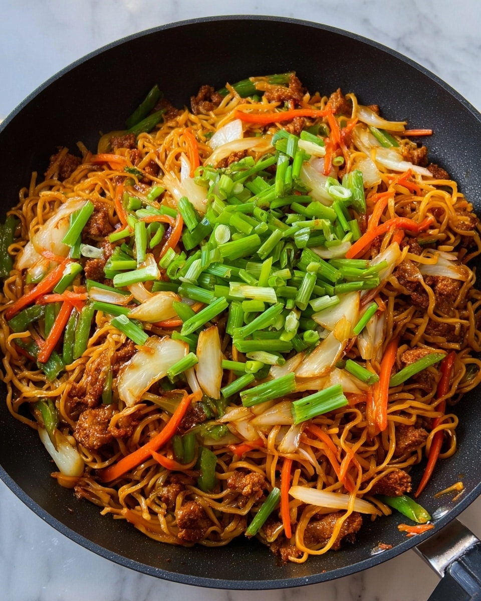 The image shows a black frying pan filled with a colorful stir-fry dish. The bottom layer consists of brown stir-fried noodles, slightly shiny from sauce. On top of the noodles, there are small pieces of browned meat mixed with thin strips of orange carrots and translucent white onion slices. The final top layer is scattered with bright green chopped spring onions. The scene is set on a white marbled surface. Photo taken with an iphone --ar 4:5 --v 7
