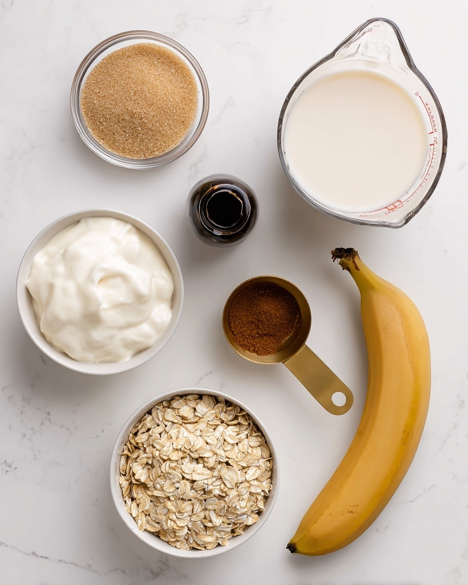 The image shows six ingredients arranged neatly on a white marbled surface. From top left, there is a small clear glass bowl filled with light brown sugar, next to it on the right is a glass measuring cup filled with creamy white liquid, and a small dark bottle with a black liquid inside. Below, there's a white bowl filled with thick white yogurt on the left side, a small clear bowl with brown cinnamon powder in the middle, a yellow frozen banana on the right, and a gold measuring cup filled with rolled oats at the bottom. The scene is simple and bright with soft shadows. Photo taken with an iphone --ar 4:5 --v 7