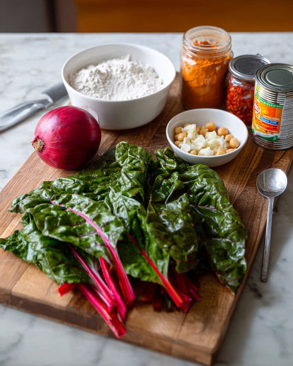 A wooden cutting board holds fresh green Swiss chard with bright red stems spread across its right side, while a whole red onion sits on the left. Behind the onion, a white bowl filled with white flour and a metal spoon stands on the marbled white surface. At the back, there are three small containers: one jar with chopped red peppers, one jar of orange powder, and a can of garbanzo beans with a white bowl filled with minced garlic beside it. The background is softly blurred, focusing on the ingredients. Photo taken with an iphone --ar 4:5 --v 7