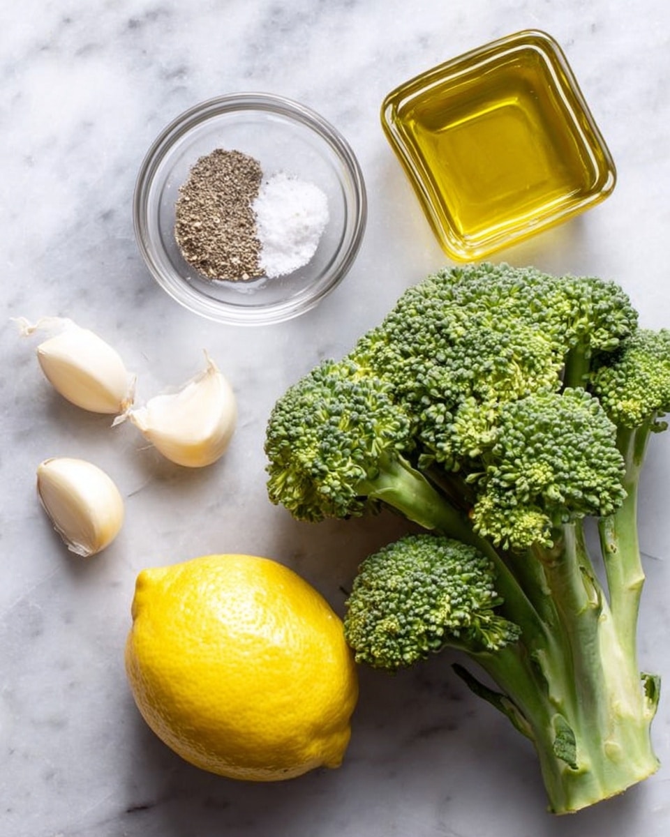 The image shows a white marbled surface with fresh cooking ingredients arranged neatly. On the right side, there is a large green broccoli with detailed textured florets and stems. Towards the bottom left, a bright yellow lemon with a shiny skin is placed. Above the lemon, a small clear glass bowl holds salt and black pepper side by side, showing their fine granules clearly. Next to this bowl is a square glass container filled with golden oil that glistens under the light. On the far left, two peeled garlic cloves rest separately, with smooth and slightly curved shapes. photo taken with an iphone --ar 4:5 --v 7