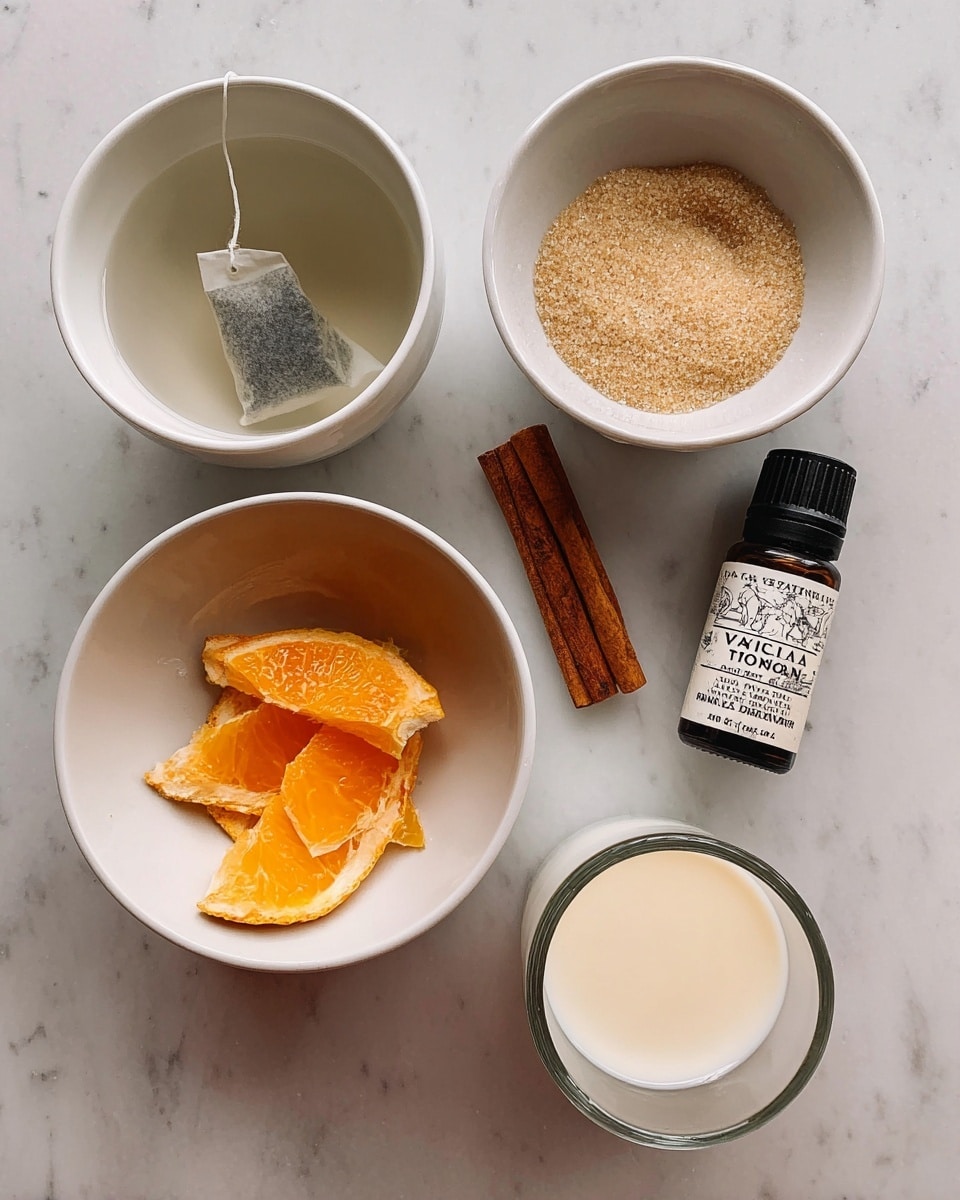 The image shows five separate items arranged on a white marbled surface. On the top left, there is a small white bowl with a tea bag placed in clear water, the tea bag paper and string visible. To its right, another small white bowl holds light brown sugar with a slightly coarse texture. Below these two, a bigger white bowl contains bright orange peel strips and a single cinnamon stick placed side by side. To the right of this bowl is a small dark bottle labeled
