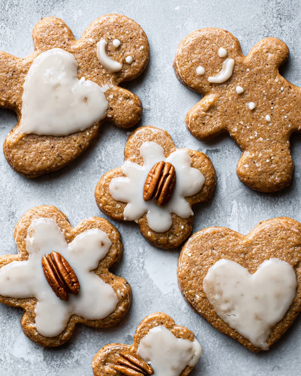 Five brown cookies shaped like a gingerbread person, flowers, and hearts are arranged on a surface with a white marbled texture. Each cookie has a shiny white glaze spread unevenly on top, giving a slightly glossy look. In the middle of each cookie, there is a pecan half pressed into the dough. The cookies show a soft, textured surface with some small air bubbles. Photo taken with an iphone --ar 4:5 --v 7