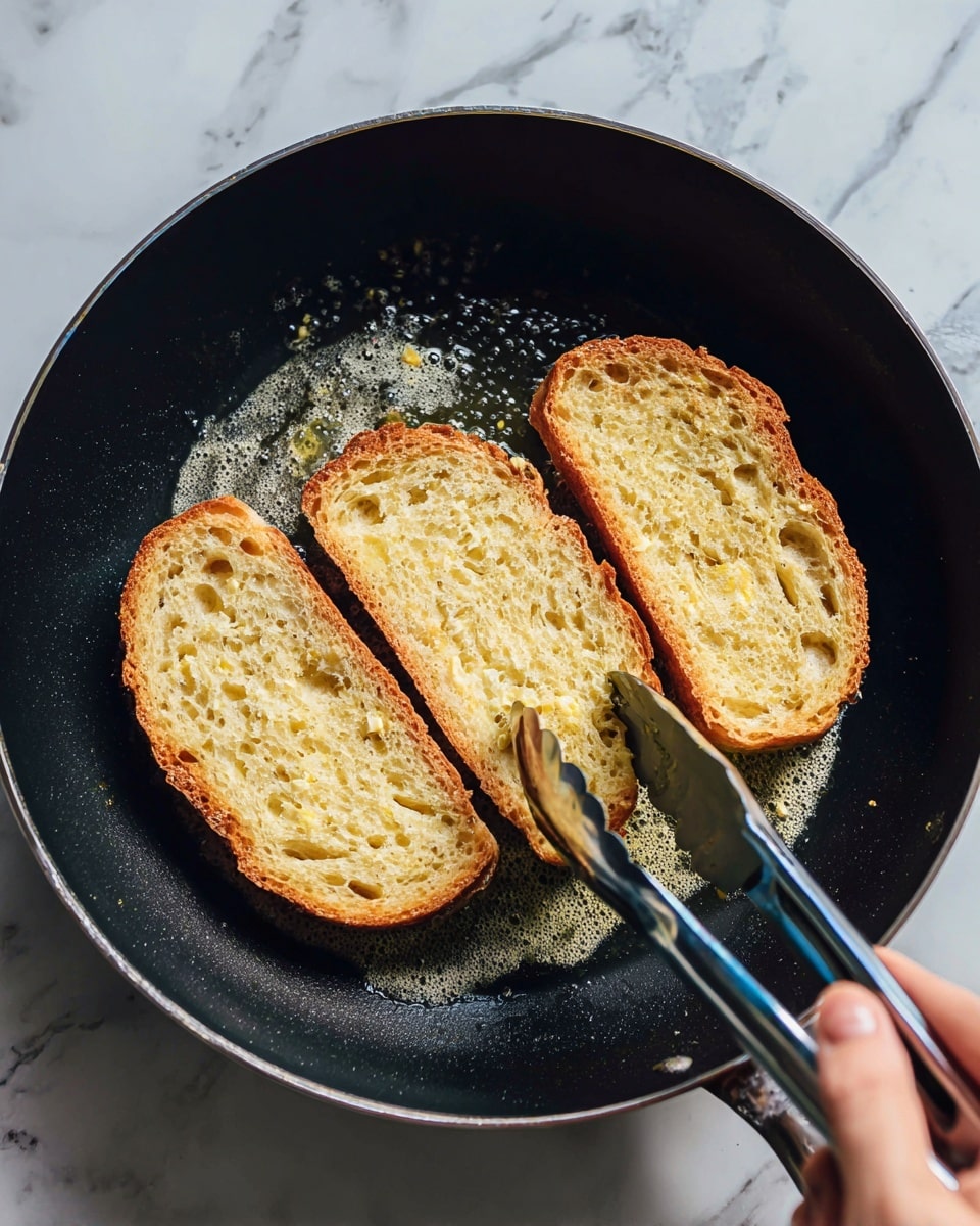 Three slices of light golden brown bread with soft, holey texture are frying in a black pan with bubbling melted butter. A woman's hand is holding silver and blue tongs, flipping one slice. The pan’s dark surface contrasts with the light bread, showing the heat and cooking process. The background has a white marbled texture. photo taken with an iphone --ar 4:5 --v 7