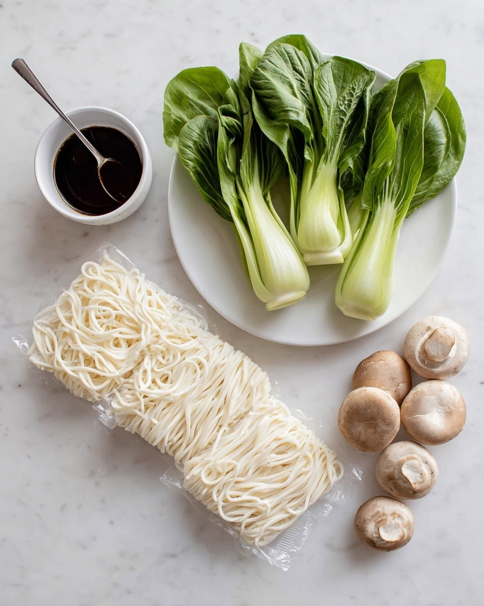 The image shows three packs of white udon noodles arranged in a slight diagonal line on a white marbled surface. Above the noodles, there is a white plate holding four fresh bok choy pieces with bright green leaves and light green stems, accompanied by five light brown mushrooms with smooth caps. To the left of the noodles, there is a small white bowl filled with dark soy sauce and a metal fork resting inside it. Photo taken with an iphone --ar 4:5 --v 7