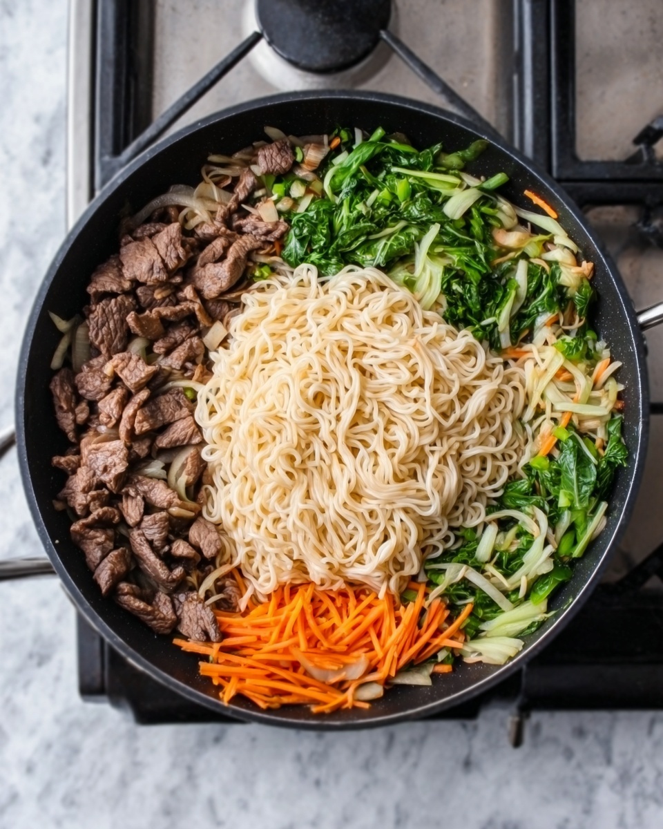 The image shows a black frying pan filled with a colorful mix of ingredients, set on a stove with a white marbled surface. The pan contains a central pile of light beige noodles, surrounded by cooked pieces of brown meat on one side, bright green leafy vegetables on another, and thin orange strips of carrots next to the greens. The textures range from soft and tender for the meat and noodles to fresh and crisp for the vegetables. The overall composition is vibrant and neatly organized within the pan. Photo taken with an iphone --ar 4:5 --v 7