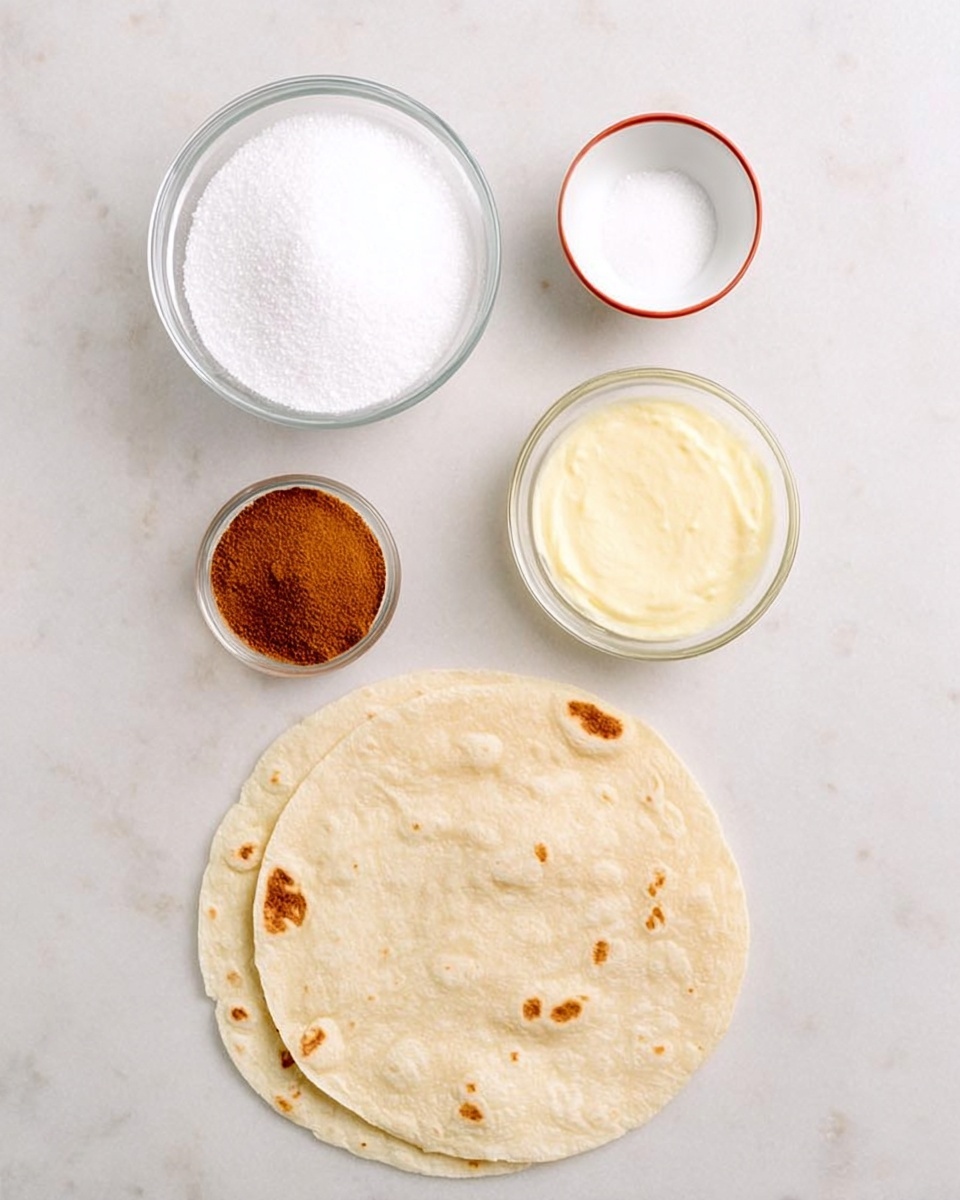 The image shows a top view of ingredients placed on a white marbled surface. There are two tortillas at the bottom, light beige in color with small brown spots. Above the tortillas, there is a large clear glass bowl filled with white granulated sugar on the left. To the right of the sugar, there is a smaller clear glass bowl holding a pale yellow powdery substance. At the top center, a small white bowl with a thin red rim contains a brown powder. The arrangement is neat and spaced out, with the bowls positioned above the tortillas photo taken with an iphone --ar 4:5 --v 7