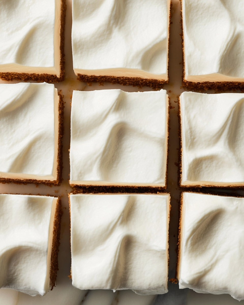 The image shows a close-up of a dessert cut into 12 square pieces arranged in a grid. Each piece has two layers: a thin brown base layer that looks slightly crumbly, and a thick, smooth top layer of white cream with soft waves and small peaks. The squares are neatly separated by thin cuts, and the texture of the cream is soft and fluffy. The dessert rests on a white marbled surface. photo taken with an iphone --ar 4:5 --v 7