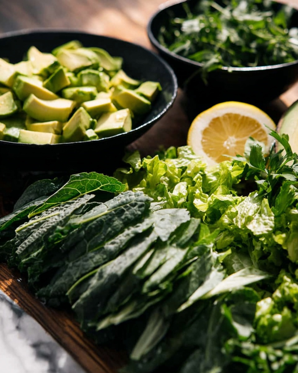 The image shows a close-up of chopped fresh greens and avocado pieces on a wooden surface. In the front, there is a long layer of thinly sliced dark green leafy lettuce with a slightly rough texture. Behind it, there is a black bowl filled with medium-sized green avocado pieces with smooth, light green flesh and darker green skin visible on some chunks. Further back, there is another black bowl containing green leafy herbs and a cut yellow lemon half laying on top. The background surface is a white marbled texture, and natural light casts soft shadows on the vegetables. Photo taken with an iphone --ar 4:5 --v 7