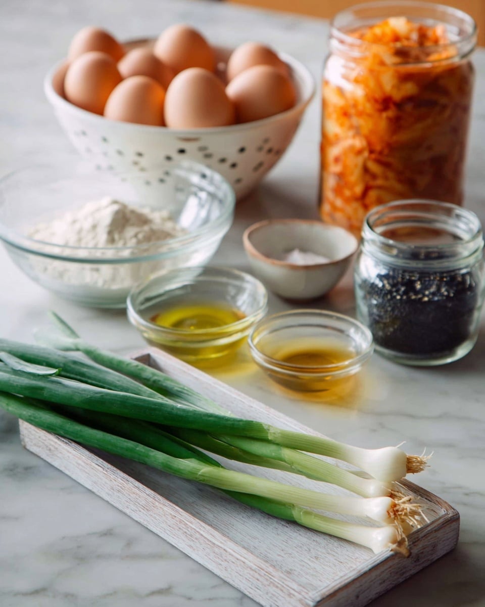 The image shows several cooking ingredients placed on a white marbled surface. In the foreground, a small white wooden tray holds three long green onions with white roots. Behind the tray, from left to right, there is a clear glass bowl with white flour, a small clear glass bowl with yellow oil, and a small glass jar filled with black sesame seeds. Further back, a white colander contains four brown eggs, and next to it is a white bowl filled with orange-colored kimchi. A jar with an orange lid and contents is partially visible at the top right corner. Photo taken with an iphone --ar 4:5 --v 7