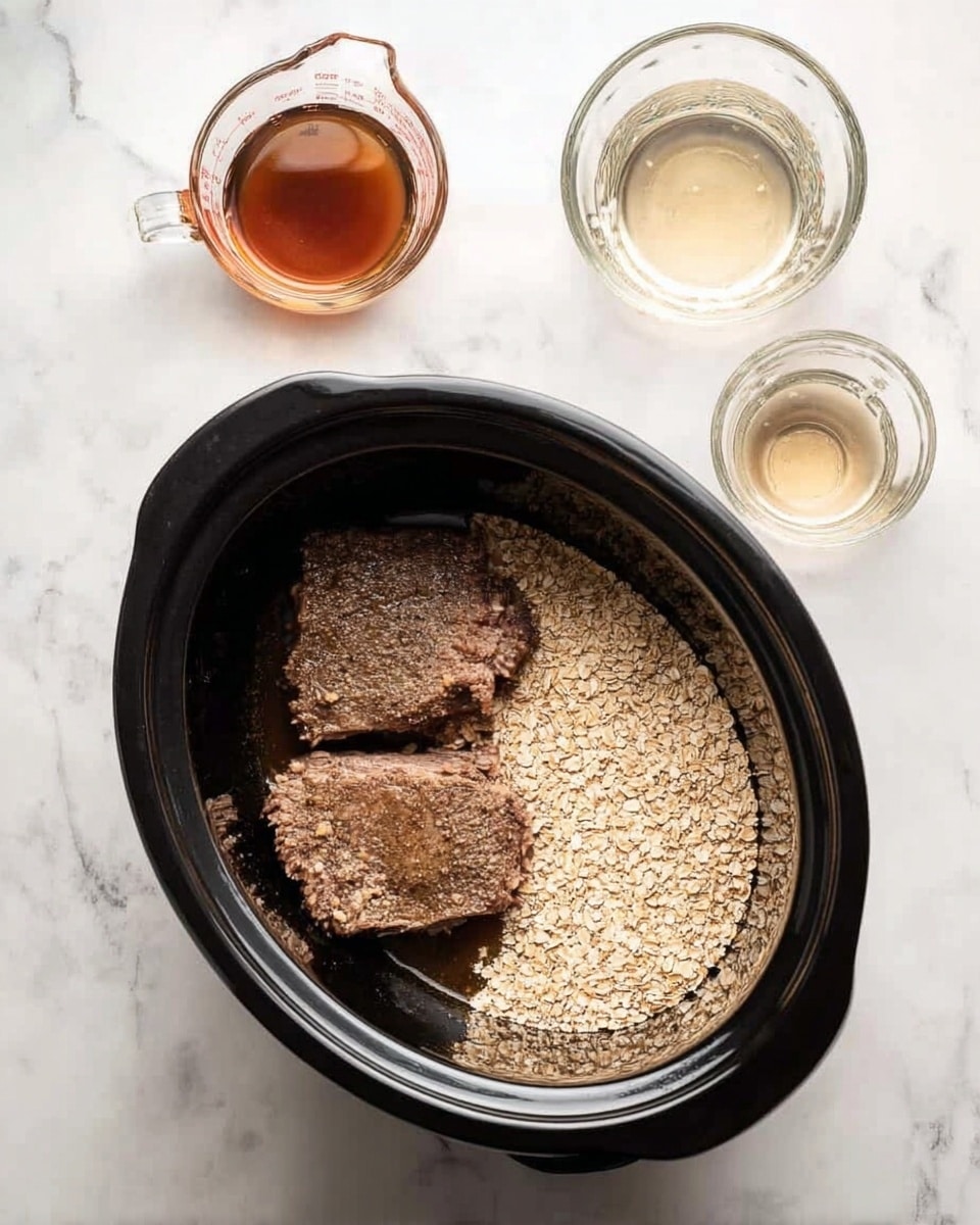 A black slow cooker is shown from above on a white marbled surface, filled with two large pieces of brown cooked meat on the left side and a heap of light beige dry oats sprinkled densely on the right side, creating two clear sections inside the cooker. Next to the slow cooker on the upper left is a small clear glass measuring cup with a brown liquid inside, and on the upper right is another small clear glass measuring cup filled with a clear liquid. The scene is simple with no other items present. Photo taken with an iphone --ar 4:5 --v 7