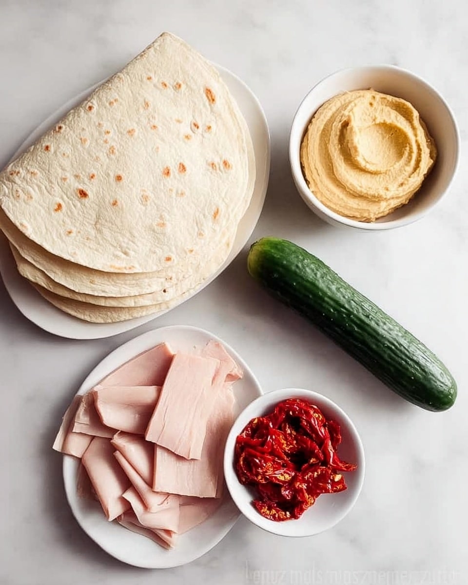 The image shows ingredients laid out on a white marbled surface. On the left, there is a stack of six soft, pale beige tortillas. Above the tortillas is a small white bowl filled with smooth, creamy light brown hummus. To the right of the hummus bowl, there is another small white bowl containing bright red, dry sun-dried tomatoes. Below the sun-dried tomatoes, a white plate holds several thin, pale pink slices of turkey meat. To the far right of the plate, there is a whole dark green cucumber resting on the white marbled surface. Photo taken with an iphone --ar 4:5 --v 7