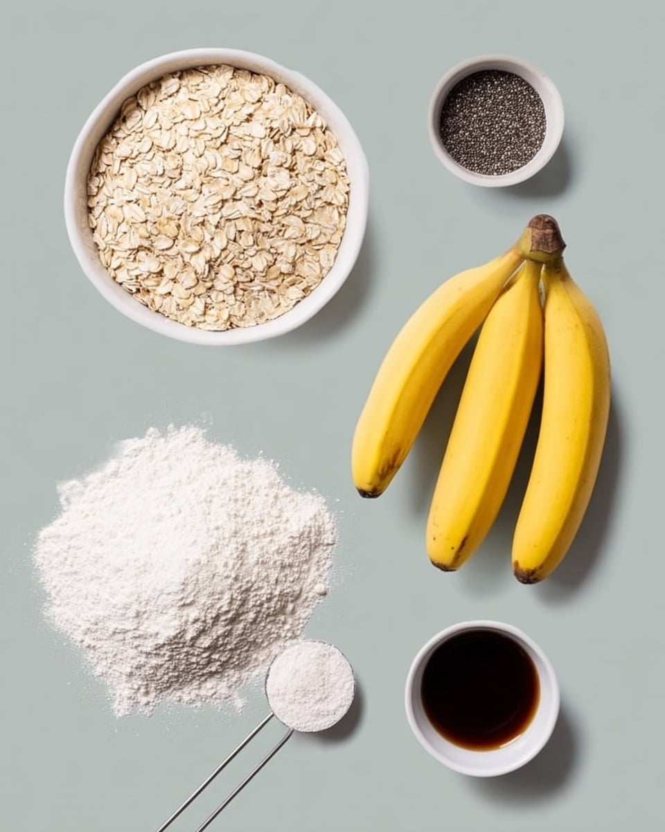 The image shows ingredients on a white marbled surface arranged neatly. At the top left, there is a white bowl filled with light beige rolled oats. Below it is a small white bowl with tiny black chia seeds. On the right side, three yellow bananas are grouped together, showing their smooth skin and brown tips. Below the bananas, there is a small white bowl with dark brown liquid, likely vanilla extract. At the bottom left, there is a large pile of white flour with a silver measuring spoon partially buried in it. photo taken with an iphone --ar 4:5 --v 7