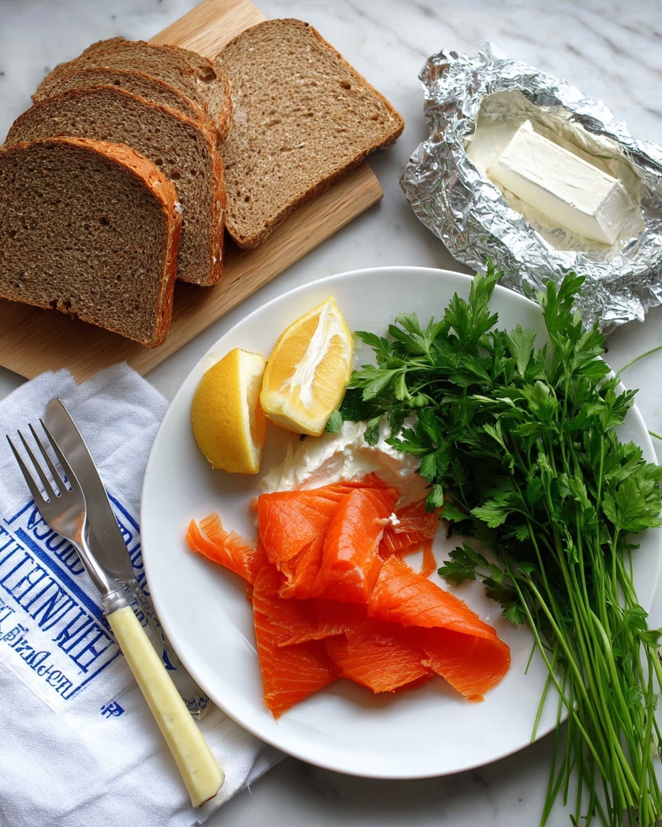 A white plate shows four slices of bright orange smoked salmon arranged in a small pile on the right side. Above the salmon there is a bunch of fresh green parsley with long stems. To the right of the parsley, there is a silver foil holding a soft white cream cheese wedge with a silver spoon resting on it. Two lemon wedges sit on the left side of the parsley. A silver fork with a pale yellow handle lies on the plate edge near the salmon. On the left side of the image, three slices of brown whole grain bread rest on a light wooden board. A white cloth with blue text is placed below the bread on the white marbled surface. Photo taken with an iphone --ar 4:5 --v 7
