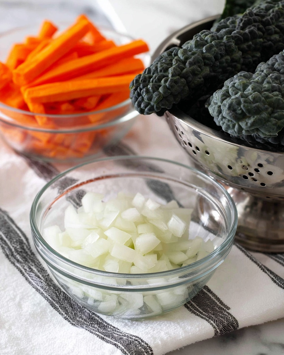 The image shows three separate containers on a white marbled surface. In the foreground, there is a clear glass bowl filled with finely chopped white onions, showing small, soft-focus cubes. To the left and further back, there is another clear glass bowl filled with orange carrot sticks, cut into uniform small sticks. On the right side, a silver metal colander holds several large, dark green curly kale leaves with a rough, crinkled texture. All containers rest on a white cloth with black stripes. Photo taken with an iphone --ar 4:5 --v 7