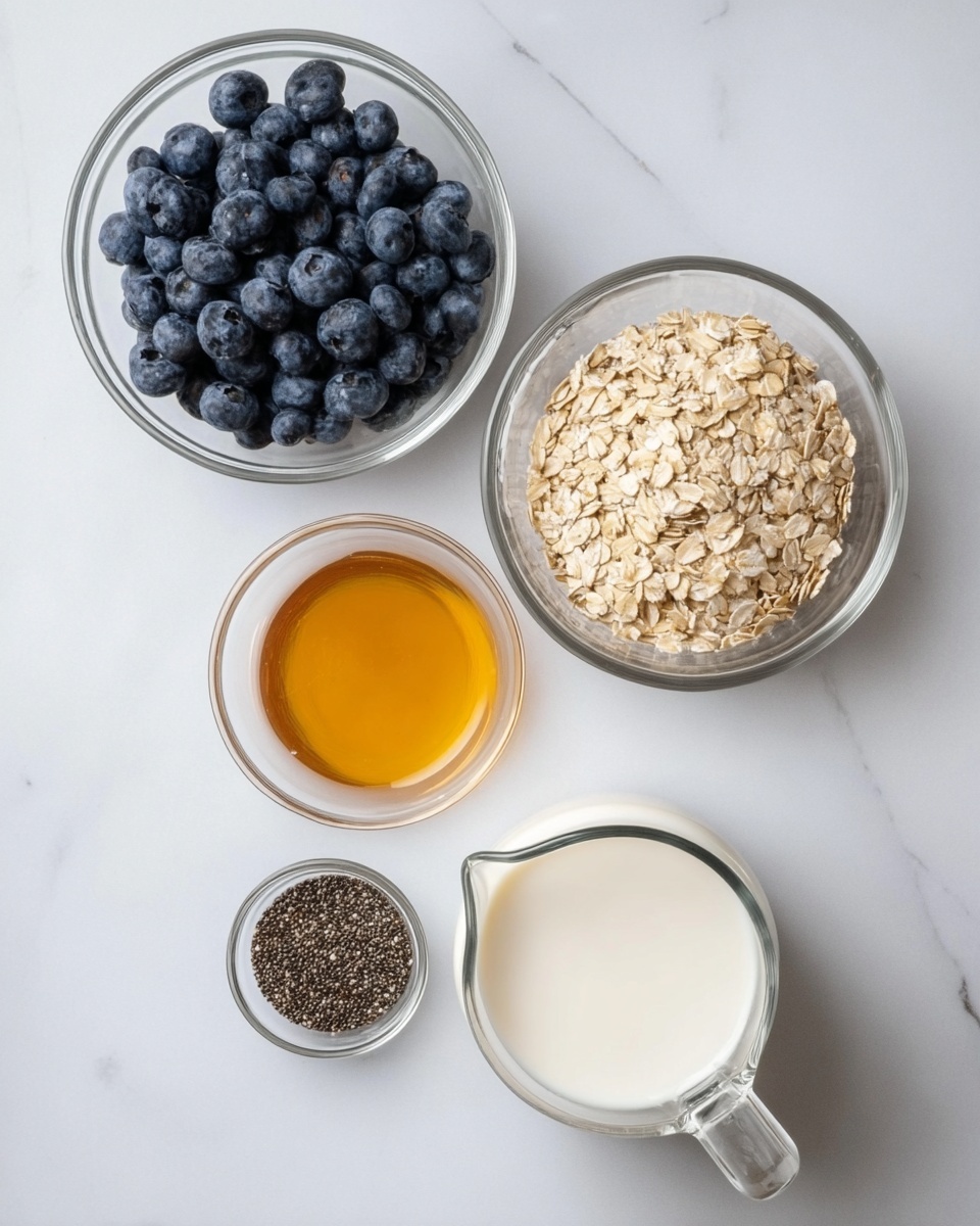 The image shows five clear glass bowls and a glass jug placed on a white marbled surface. From the top left, there is a bowl filled with fresh, dark blue blueberries; next to it on the right, a larger bowl contains light beige oats. Below the blueberries, a smaller bowl holds golden honey with a smooth texture, and to the left of the honey, another small bowl is filled with tiny black chia seeds. At the bottom right of the image, a glass jug is filled with white milk, showing a smooth and liquid texture. All containers are transparent, and the clean, bright white marbled background highlights the natural colors and textures of the ingredients. Photo taken with an iphone --ar 4:5 --v 7