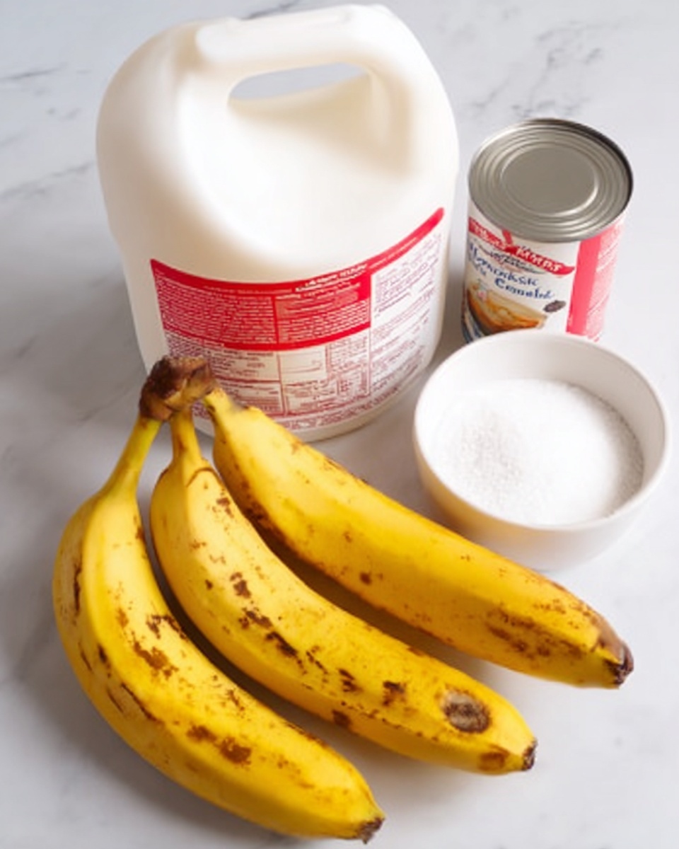 The image shows a group of ripe yellow bananas with brown spots on their skin, a white plastic gallon milk jug with a red and white label, a small open can of sweetened condensed milk with a silver lid, and a white bowl filled with white granulated sugar. All items are placed on a white marbled surface. The arrangement is simple, with the bananas lying in a bunch on the left, the milk jug behind them, the sugar bowl in front, and the can of condensed milk to the right. Photo taken with an iphone --ar 4:5 --v 7