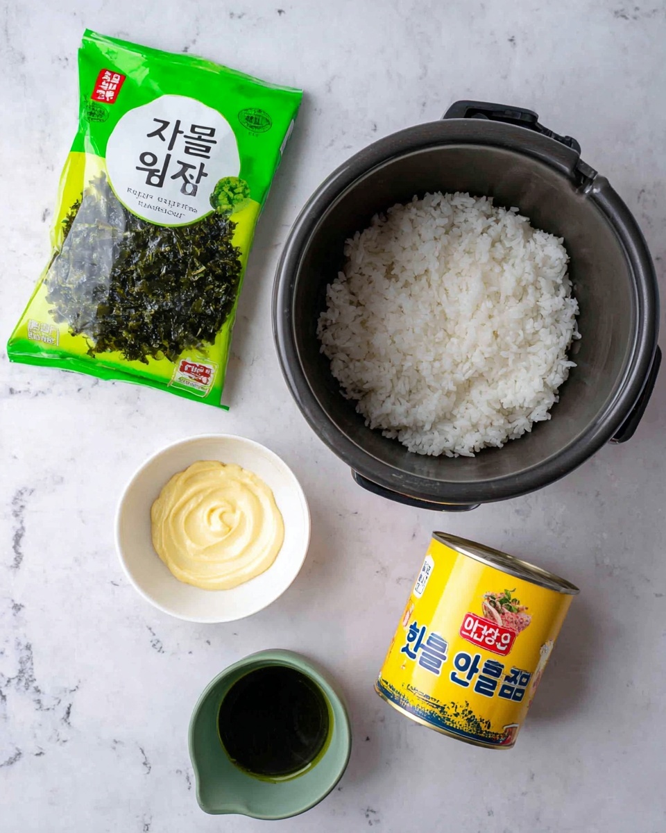 The image shows a set of ingredients arranged neatly on a white marbled surface. At the top right is a black rice cooker pot filled with white cooked rice, showing fluffy and soft texture. On the left side, there is a bright green and white packet of roasted green tea seaweed with Korean characters and an image of dark green seaweed leaves. Below the rice cooker pot, there is a small white bowl containing light yellow mayonnaise with a smooth, swirled top. Next to it is a green cup with dark liquid inside, possibly oil or soy sauce. At the bottom right, a bright yellow can with a red and blue label containing Korean text is placed, likely canned tuna. All items are arranged so their colors and textures stand out clearly. Photo taken with an iphone --ar 4:5 --v 7