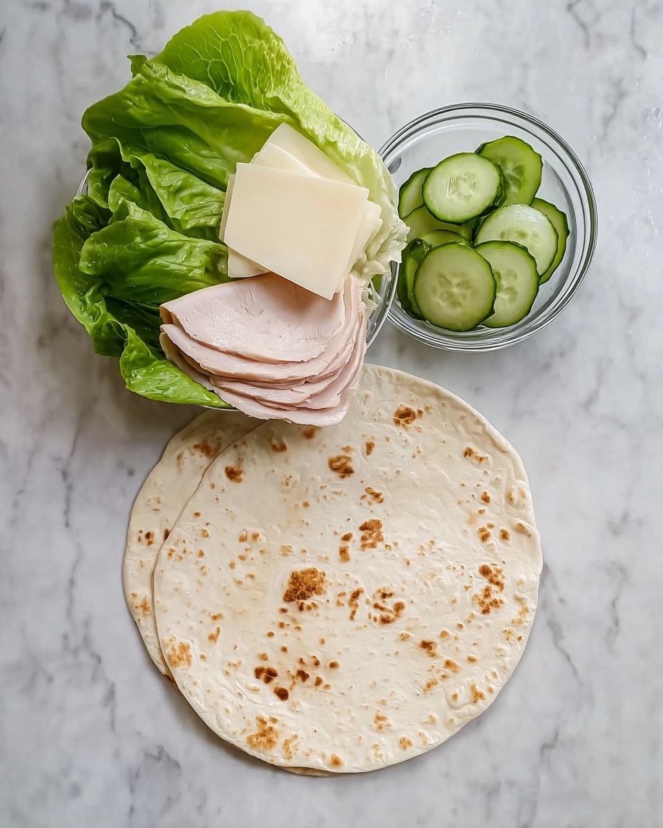 The image shows a round, light beige flat tortilla with brown spots on a white marbled surface. Above the tortilla is a transparent white plate holding two large green lettuce leaves on the left side, two slices of pale pink turkey meat in the middle, and two white cheese slices on the right side. A small clear glass bowl filled with thinly sliced green cucumbers is placed on top of the lettuce and turkey meat. The composition is simple and clean, with fresh and soft textures. Photo taken with an iphone --ar 4:5 --v 7