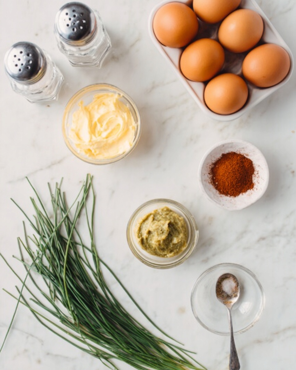 The image shows a top view of cooking ingredients placed on a white marbled surface. There is a white container holding six brown eggs in the top right corner. At the top left, there are two clear salt and pepper shakers with metal caps. Below them, a small clear bowl contains a light yellow creamy substance. Towards the bottom left, a bunch of green chives is laid out with thin, long stalks. Near the bottom center is a small clear bowl with a greenish-yellow paste and a small spoon resting in it. To the right of the bowl with the paste is a small white bowl with a red-brown powder spice. Photo taken with an iphone --ar 4:5 --v 7