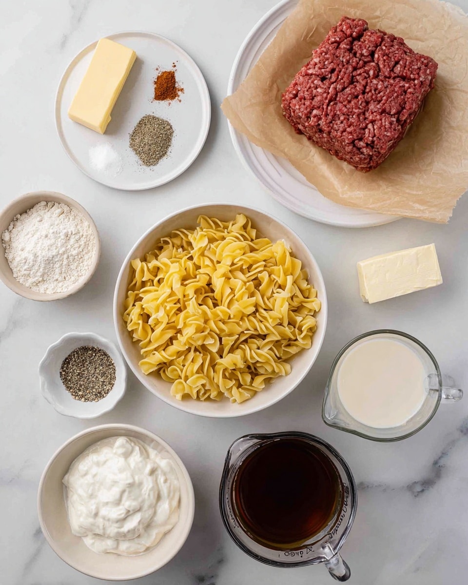 The image shows an overhead view of several ingredients arranged neatly on a white marbled surface. At the top right, a white bowl lined with brown parchment paper holds a block of ground meat, dark red in color with a coarse texture. Above the center, a white plate holds small piles of salt, pepper, garlic powder, and paprika. To the left, a small beige bowl contains white flour. At the center bottom, a white bowl is filled with uncooked yellow egg noodles with a slightly twisted shape. Below the noodles, a small beige bowl holds a thick white creamy substance. To the right, a clear glass measuring cup contains a light beige liquid, likely milk. At the bottom right, another clear glass measuring cup is filled with a dark brown liquid, likely broth. A small rectangular stick of pale yellow butter is on a small white plate at the top left. All items are spaced evenly and well-lit, with soft shadows. Photo taken with an iphone --ar 4:5 --v 7
