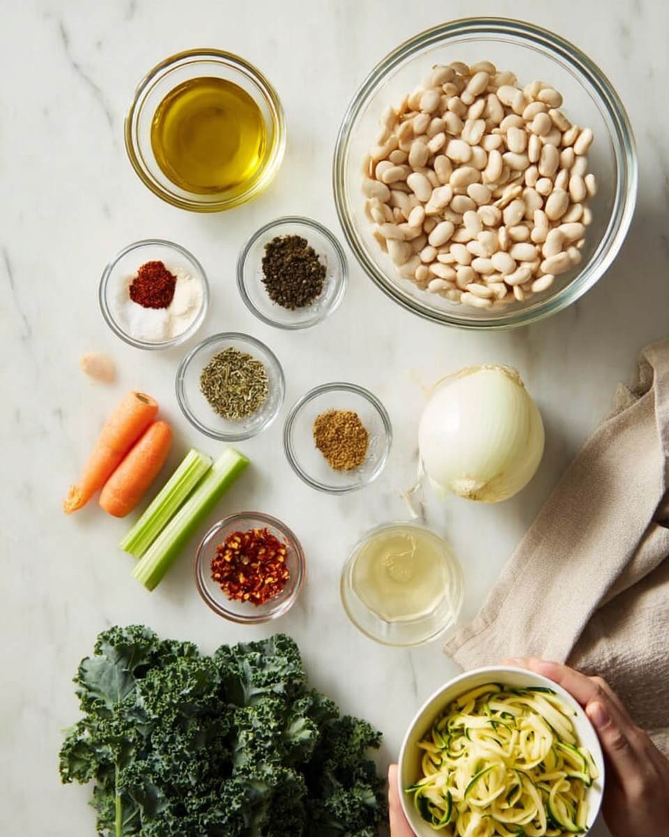 A top-down view of several clear glass bowls and loose ingredients arranged neatly on a white marbled surface. The largest bowl, positioned at the upper right, holds a full pile of white beans. Below and slightly left are smaller dishes containing varied spices like black pepper, oregano, red chili flakes, and salt, each with different textures and colors ranging from light brown to dark green and red. There is a raw white onion next to a small bowl with a pale yellow liquid, likely oil, and another with a transparent liquid, possibly vinegar. Two orange carrots and a green celery stalk lie side by side to the lower left of the bowls. Fresh bright green kale leaves form a thick bunch below the carrots and celery. A woman's hand slightly visible is holding a white bowl filled with pale yellow zucchini ribbons or shavings toward the right. A beige cloth is partially seen at the bottom right corner. photo taken with an iphone --ar 4:5 --v 7