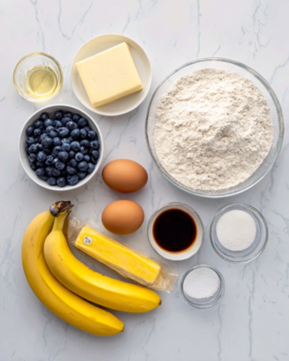 The image shows ingredients for a recipe arranged neatly on a white marbled surface. There is a large transparent bowl filled with white flour on the right side, and next to it is a smaller clear bowl containing white sugar. In front of the flour bowl are two brown eggs placed side by side on the surface. To the left, there is a small white bowl filled with fresh blueberries and a clear glass with a yellow liquid, likely vanilla or oil. Below these, two bright yellow bananas rest on the marble. A stick of butter wrapped in light yellow paper sits near the bananas. Additionally, a small white bowl with a dark brown liquid and two tiny white containers of salt and baking powder complete the ingredients. The setup is clean and simple, with all items clearly visible. Photo taken with an iphone --ar 4:5 --v 7