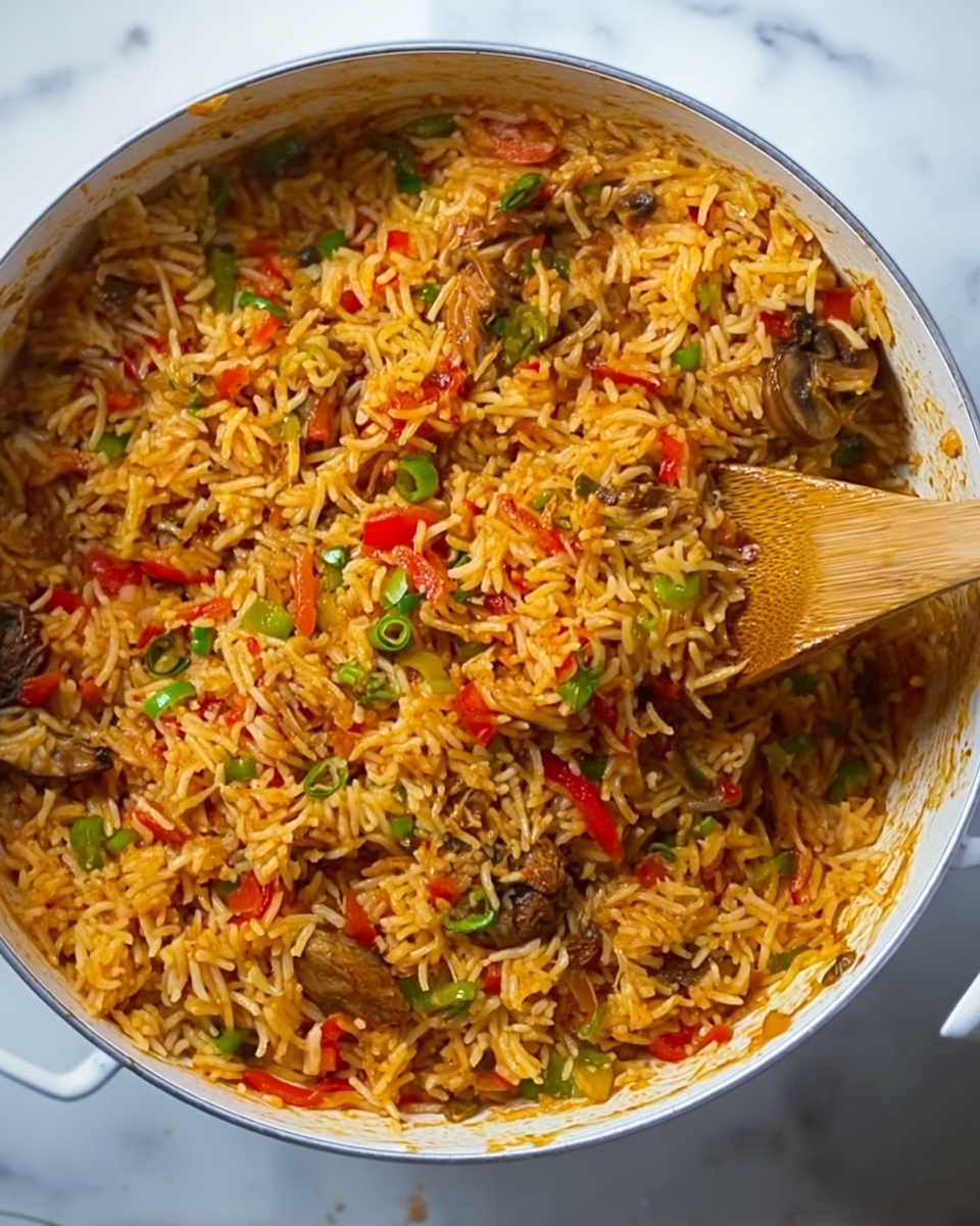 A close-up of a white pan filled with cooked rice mixed with small pieces of red and green bell peppers, along with bits of browned mushrooms and small chunks of meat. The rice is yellow-orange from the spices and sauce, with a slightly oily sheen. A woman's hand is seen stirring the rice with a wooden spoon, showing motion. The pan sits on a white marbled surface. photo taken with an iphone --ar 4:5 --v 7