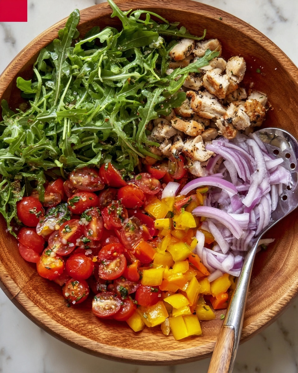 A wooden bowl filled with several fresh layers of food sits on a white marbled surface. On the bottom right, there is a layer of thinly sliced red onions with curved edges and light purple color. Next to the onions towards the center, a pile of chopped bright yellow bell peppers adds a pop of color. To the left side of the peppers and onions group, there are halved cherry tomatoes in deep red with shiny skin, mixed with small bits of herbs and seeds. Above the tomatoes, small pieces of grilled chicken with a light brown, slightly charred texture fill the bowl. On the left side of the bowl, a big bunch of leafy green arugula with thin stems and slightly curly edges forms one whole layer. A silver slotted spoon is placed on the arugula near the front edge of the bowl. The photo taken with an iphone --ar 4:5 --v 7