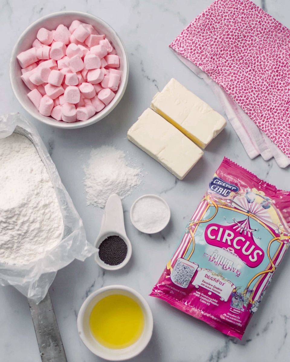 The image shows several baking ingredients arranged on a white marbled surface. There is a white bowl filled with pink candy pieces on the left, next to a white scoop filled with white flour. Below the flour is an open package containing two blocks of creamy white butter. To the right of the butter are two small white scoops holding white sugar and dark vanilla extract. At the bottom center is a white cup filled with melted yellow butter or oil. A colorful package featuring the words