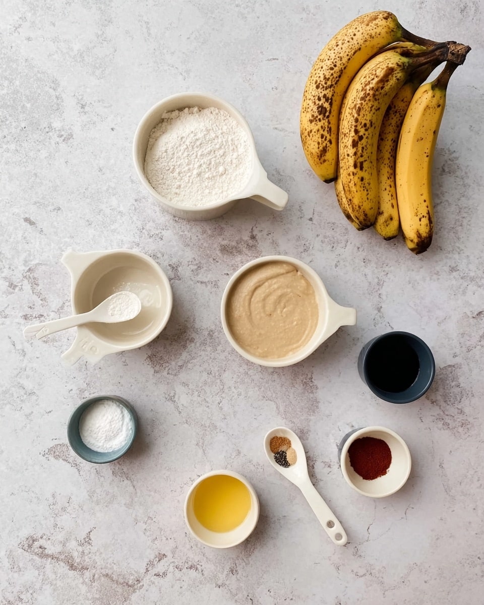 The image shows several cooking ingredients arranged neatly on a white marbled surface. At the top right, there is a bunch of ripe bananas with brown spots. Across the surface, there are seven small white bowls and measuring cups holding different ingredients: one large white measuring cup filled with flour at the left side, a smaller white measuring cup with another white powder near it, a round white bowl with a smooth beige paste, a small yellow bowl with a liquid, a white spoon with a reddish-brown powder, a small white bowl with a mix of salt and other spices, and a small dark cup with a dark liquid. The items are spaced out evenly, creating a clean and organized look. Photo taken with an iphone --ar 4:5 --v 7
