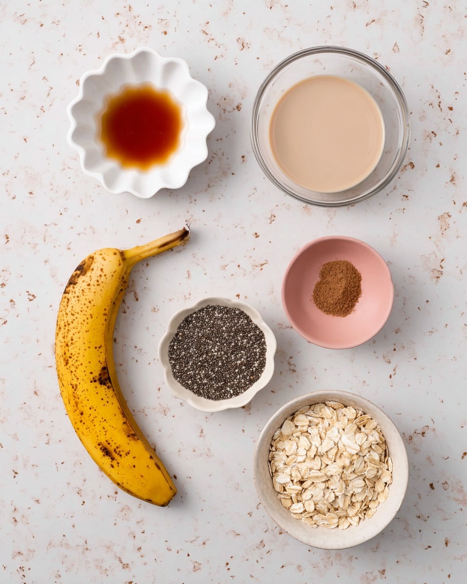 The image shows seven ingredients arranged on a white marbled surface: at the top right, a clear bowl filled with a beige liquid; to the left of it, a small white scalloped bowl with a dark amber syrup; below and slightly right, a small white bowl with black chia seeds; near the center left, a ripe yellow banana with brown spots; below the banana, a small pink bowl with brown powder; and on the bottom right, a white bowl filled with light-colored rolled oats. The items are spaced evenly, creating a clean and simple layout. photo taken with an iphone --ar 4:5 --v 7