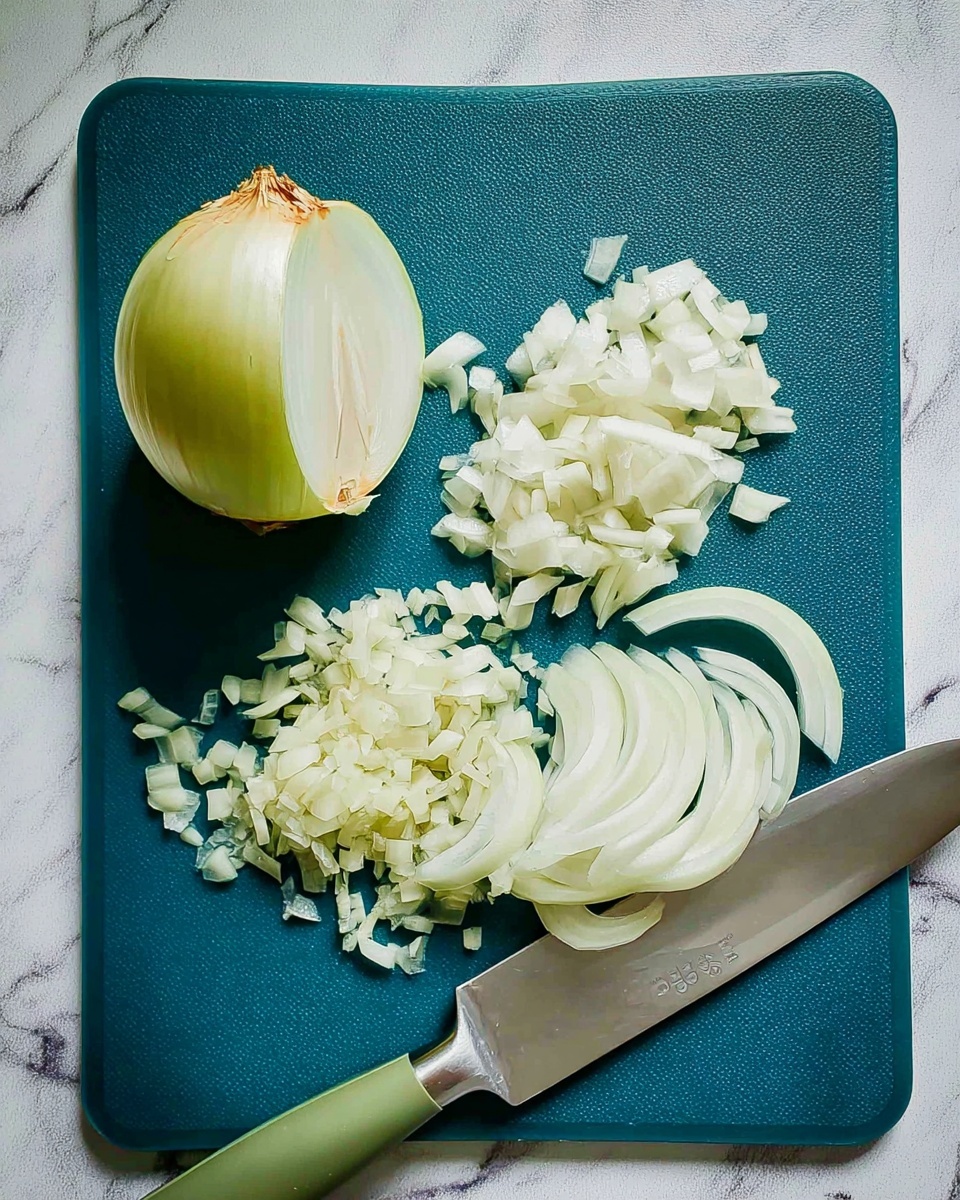 The image shows a green cutting board on a white marbled surface with one half onion placed on the left side. Next to the half onion, there is a pile of finely chopped white onion pieces. On the right side of the board, there are two neat piles of thinly sliced white onion layers, arranged in small stacks. A large knife with a silver blade and a green handle is lying diagonally across the cutting board, with the blade tip pointing towards the top left corner. The photo taken with an iphone --ar 4:5 --v 7