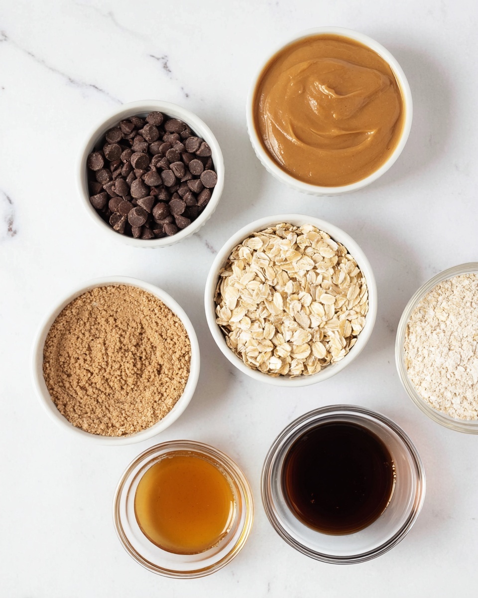 The image shows six small white bowls arranged on a white marbled surface. One bowl is filled with dark brown chocolate chips, another with light brown smooth peanut butter. A third bowl contains light beige oat flakes, filling it almost to the top. There is a bowl with a thick, light golden syrup, and two glass bowls, one with a light powdery oatmeal ingredient and the other with a dark brown liquid, possibly vanilla extract. Each bowl clearly shows the texture and color of its contents, arranged neatly with some space between them. Photo taken with an iphone --ar 4:5 --v 7
