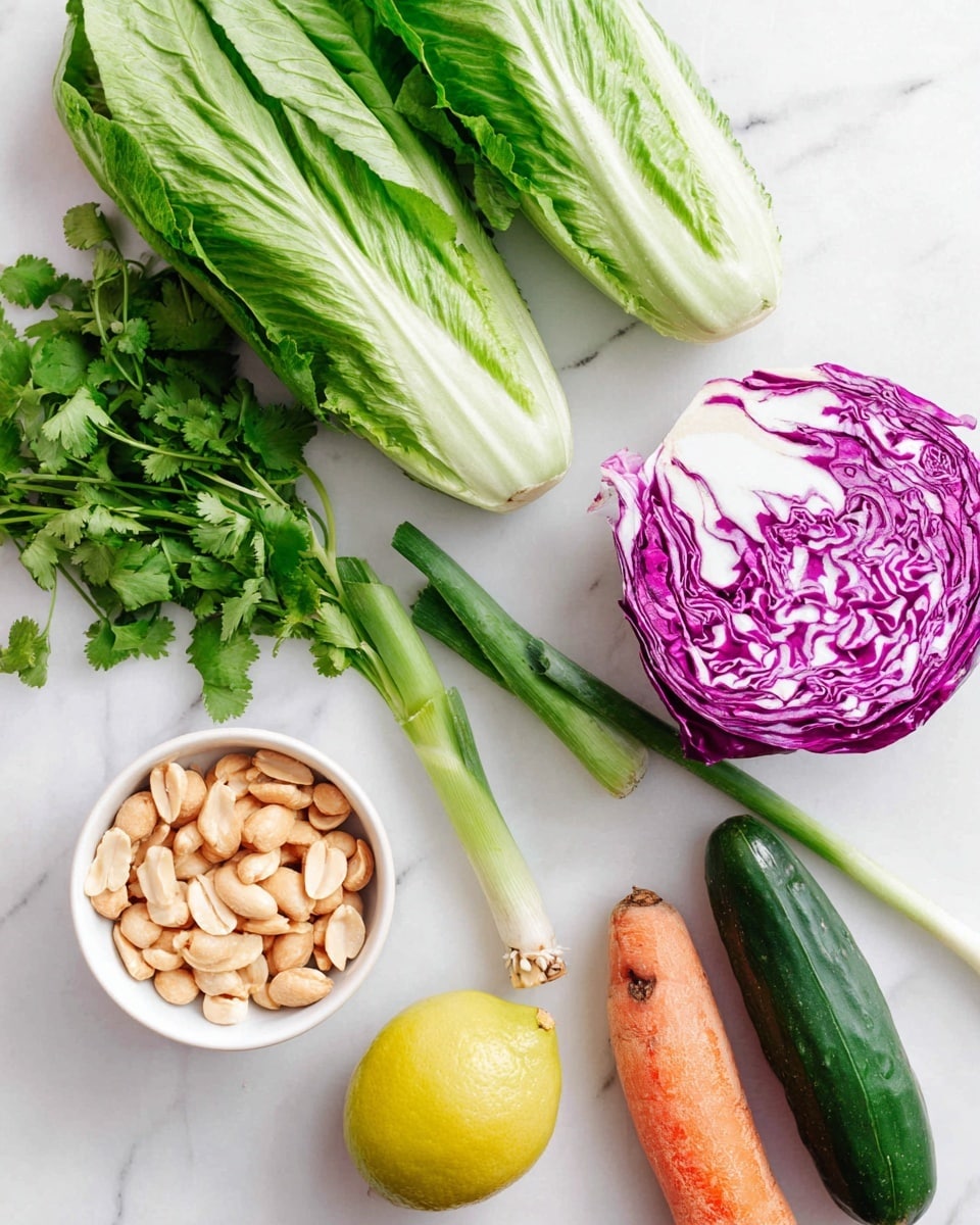 The image shows fresh ingredients arranged on a white marbled surface: three large green romaine lettuce leaves placed at the top right, followed by three long green onions lying horizontally below the lettuce. To the left, a small white bowl filled with light beige peanuts is seen. Below the bowl, a whole yellow lemon is placed next to a bunch of fresh green cilantro. To the right of the lemon and cilantro, there is a whole orange carrot with a rough texture, and at the bottom right, a dark green cucumber. Above the carrot, a half piece of purple cabbage showing white veins inside is placed. Photo taken with an iphone --ar 4:5 --v 7