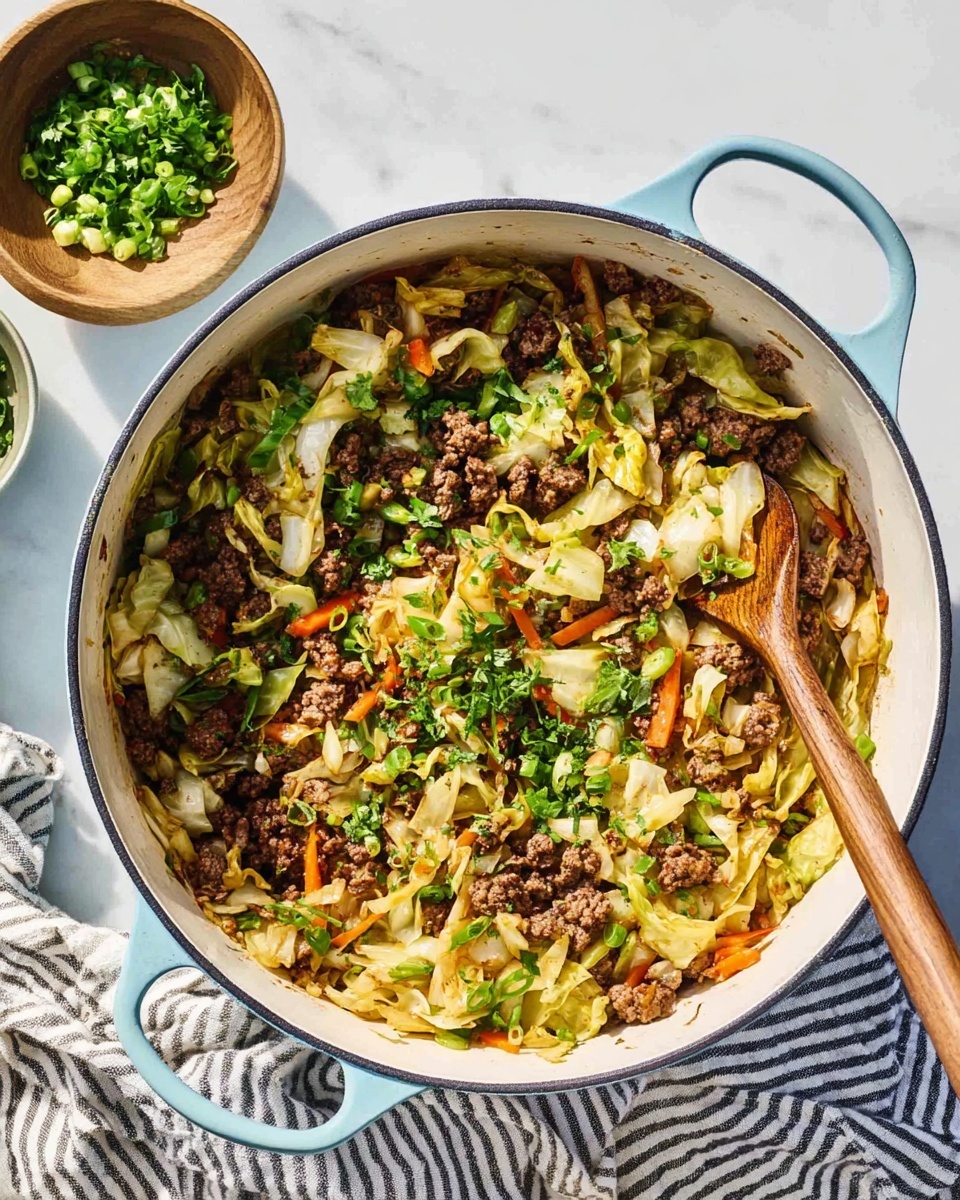 A white enameled pot with light blue handles filled with a mix of browned minced meat and sautéed cabbage strips, lightly golden and soft in texture. There are small orange carrot shreds mixed in and fresh chopped green onions and green herbs sprinkled on top, adding a pop of color. The pot rests on a white marbled surface next to a wooden spoon partially stirring the dish, with a small wooden bowl of greens nearby and a striped cloth under the pot handle. photo taken with an iphone --ar 4:5 --v 7
