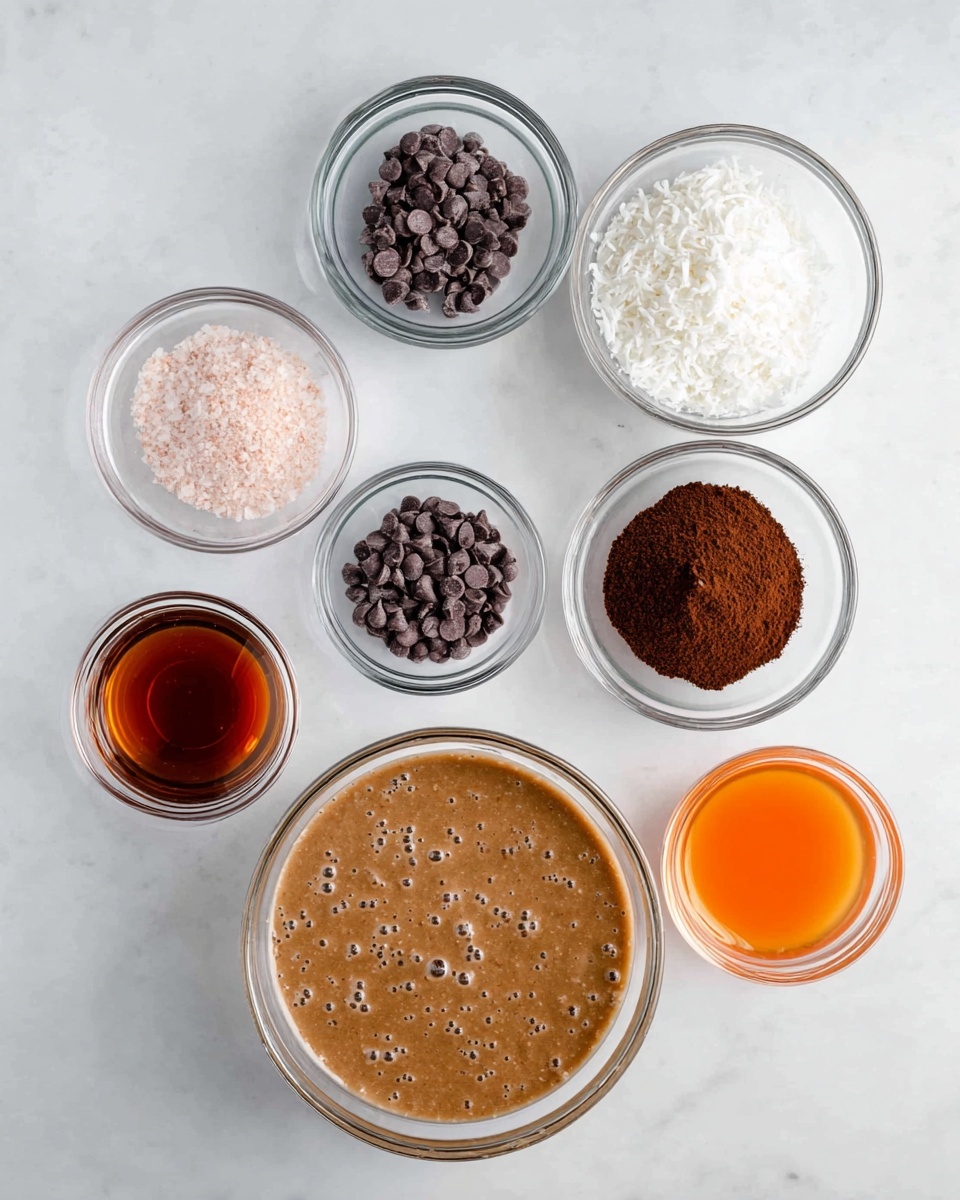 The image shows seven clear glass bowls arranged on a white marbled surface. The largest bowl at the bottom contains a thick light brown batter with small bubbles on the surface. Above it, in the middle row, three bowls display different ingredients: the left one has small dark chocolate chips, the middle one is filled with a dark brown powder, and the right one holds white shredded coconut. The top row contains three smaller bowls, the left one with light pink salt, the middle one with a dark amber liquid, and the right one with a small amount of bright orange liquid. Each bowl is transparent, showing the color and texture of its contents clearly. Photo taken with an iphone --ar 4:5 --v 7