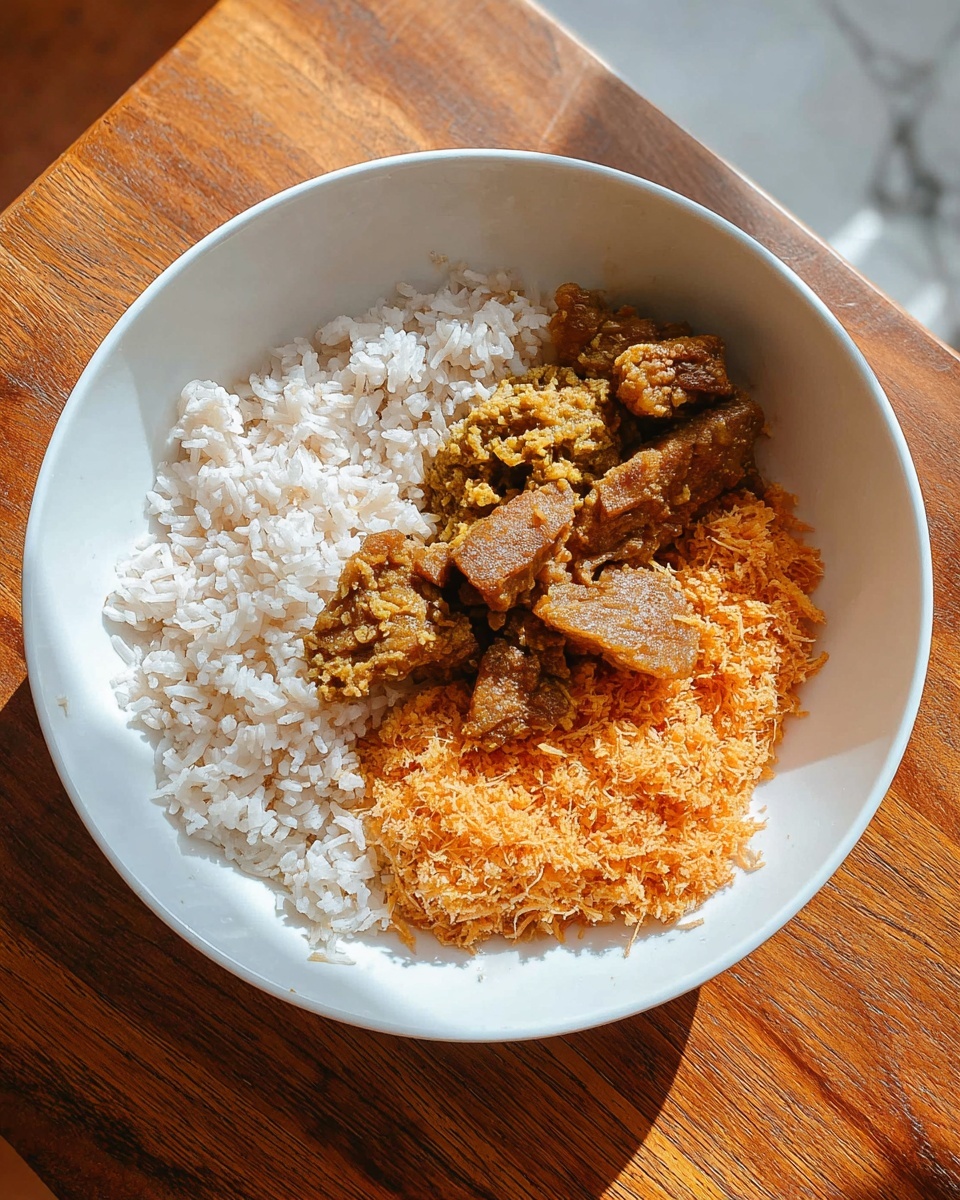 A white bowl sitting on a wooden surface contains a three-part dish: at the bottom left is a layer of plain white rice with visible individual grains, the center has a layer of brownish-yellow cooked meat pieces with a slightly oily texture, and to the right a textured layer of orange shredded coconut or similar fiber, appearing soft and moist. The bowl is shown from above with natural light casting soft shadows, and the background outside the bowl is a white marbled texture photo taken with an iphone --ar 4:5 --v 7