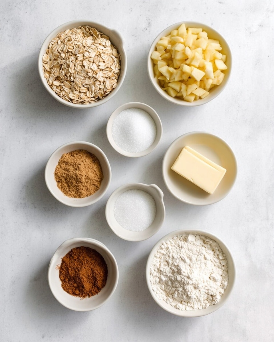 Seven small white bowls are arranged on a white marbled surface, each holding a different baking ingredient. The top right bowl contains finely chopped light yellow apples. To its left is a bowl filled with light brown rolled oats. Below the apple bowl is a small bowl with white granulated sugar, and next to it is a bowl with a light yellow stick of butter. In the middle left is a bowl holding a white powdered ingredient, likely baking soda or baking powder. At the bottom left is a bowl filled with light brown sugar, and next to it is a bowl with brown cinnamon powder. Finally, at the bottom right is a bowl containing white flour. photo taken with an iphone --ar 4:5 --v 7