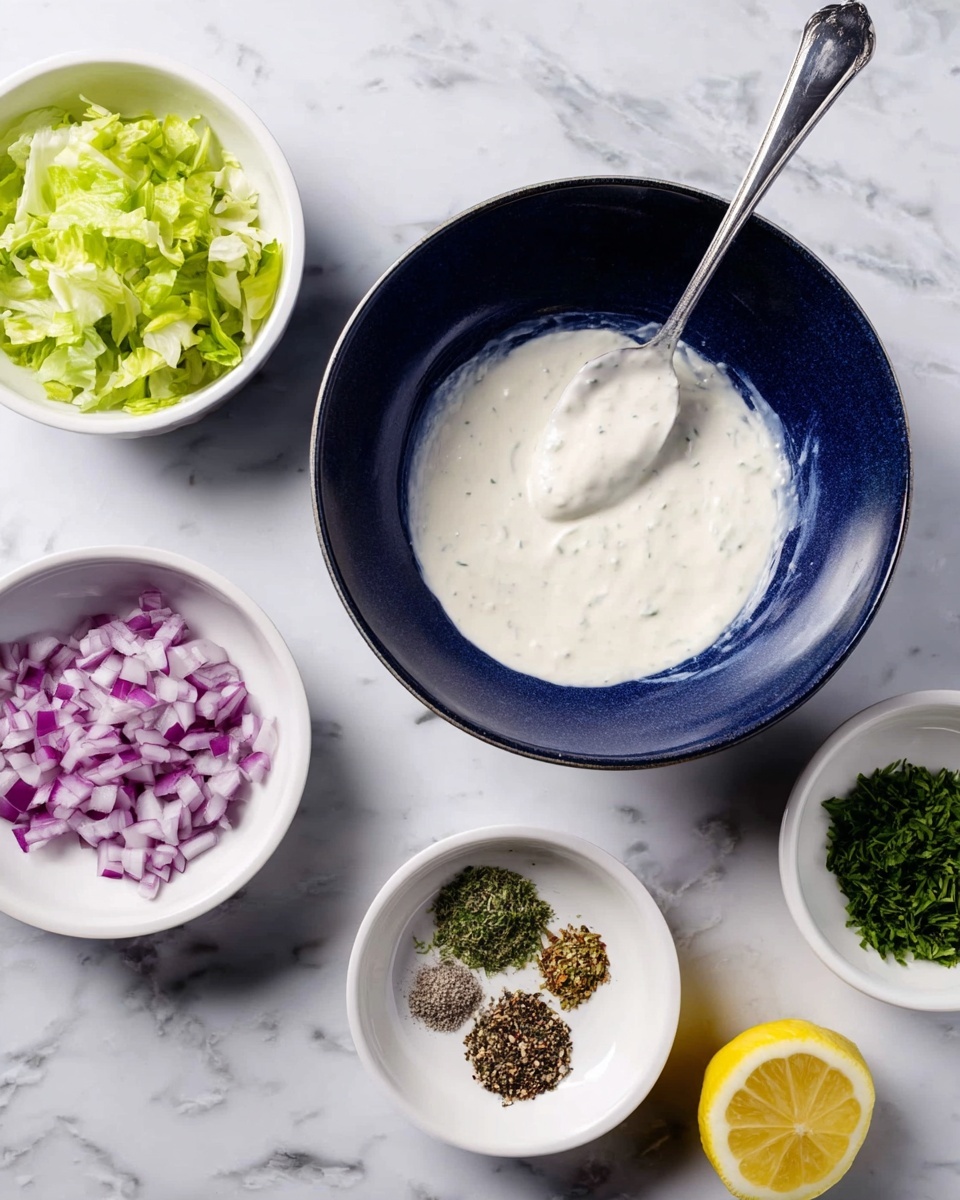 The image shows a dark blue bowl in the center, filled with white creamy sauce, with a spoon holding some of the sauce above it. Around the bowl, there are four small white bowls placed on a white marbled surface; the top left bowl holds chopped green lettuce, the bottom left bowl has finely chopped green herbs, the bottom middle bowl contains chopped red onions, and the bottom right bowl has small piles of ground black pepper, herbs, and other spices. To the right side of the arrangement is a half lemon on the marbled surface. Photo taken with an iphone --ar 4:5 --v 7