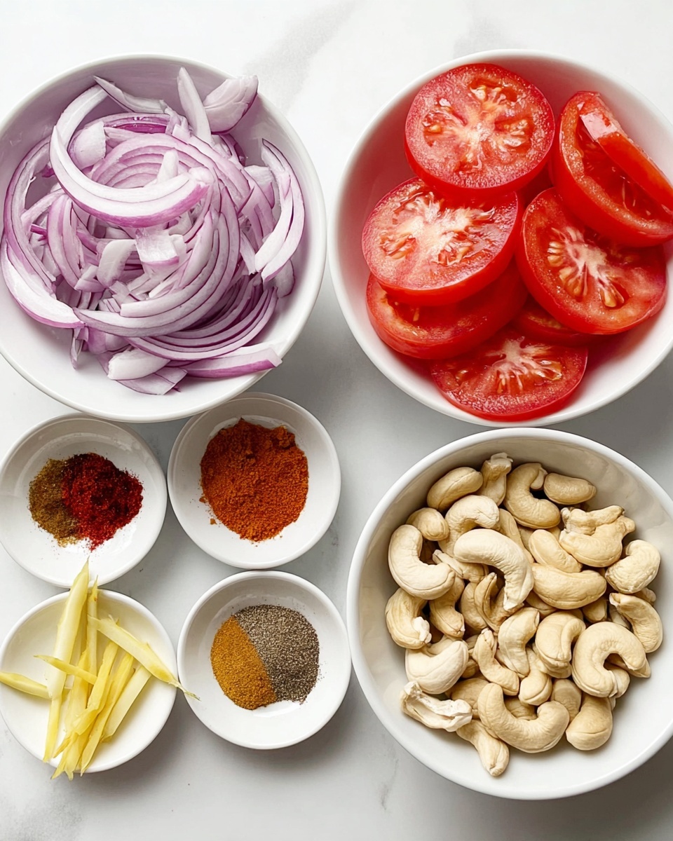 The image shows five white bowls placed on a white marbled surface, each holding different ingredients. The top left bowl is full of thinly sliced purple onions with white edges, loosely piled. The top right bowl holds tomato slices with a bright red color and juicy texture, some pieces showing seeds inside. Bottom left bowl contains peeled garlic cloves alongside thin yellow ginger strips. In the middle bottom bowl, several dry spices are arranged in small piles including red chili powder, brown and dark brown powders, and a light brown powder. The bottom right bowl is filled with whole cashew nuts, off-white in color with a smooth texture. photo taken with an iphone --ar 4:5 --v 7