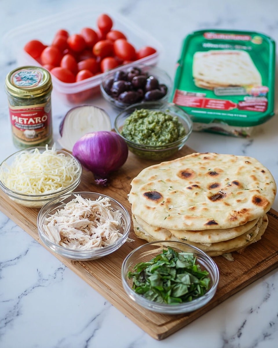 The image shows a wooden cutting board with two pieces of flatbread stacked on top, light golden in color with some darker spots. Around the board are small clear glass bowls containing shredded white chicken, shredded mozzarella cheese, and fresh chopped green basil leaves. A halved purple onion sits on the board next to the bowls. Behind the board is a small plastic container of cherry tomatoes, a jar of sliced black olives with a red label, and a green package of feta cheese. In the front right is a green container of pesto sauce. All items are placed on a surface with a white marbled texture. Photo taken with an iphone --ar 4:5 --v 7