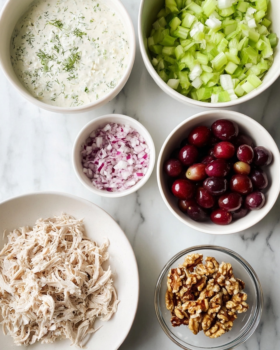 This image shows six white bowls and plates placed on a white marbled surface. One large white plate holds shredded light beige chicken in the lower left corner. Above it, a white bowl contains creamy white sauce with small green herbs mixed in. To the right, another white bowl is filled with light green chopped celery pieces. In the center, a small white bowl holds finely chopped red onions with white and purple colors. Below that, a white bowl is filled with dark red halved grapes. At the bottom right corner, there is a small clear glass bowl with chopped walnuts that are light brown. The bowls and plates create a neat arrangement, highlighting the fresh and colorful ingredients. Photo taken with an iphone --ar 4:5 --v 7