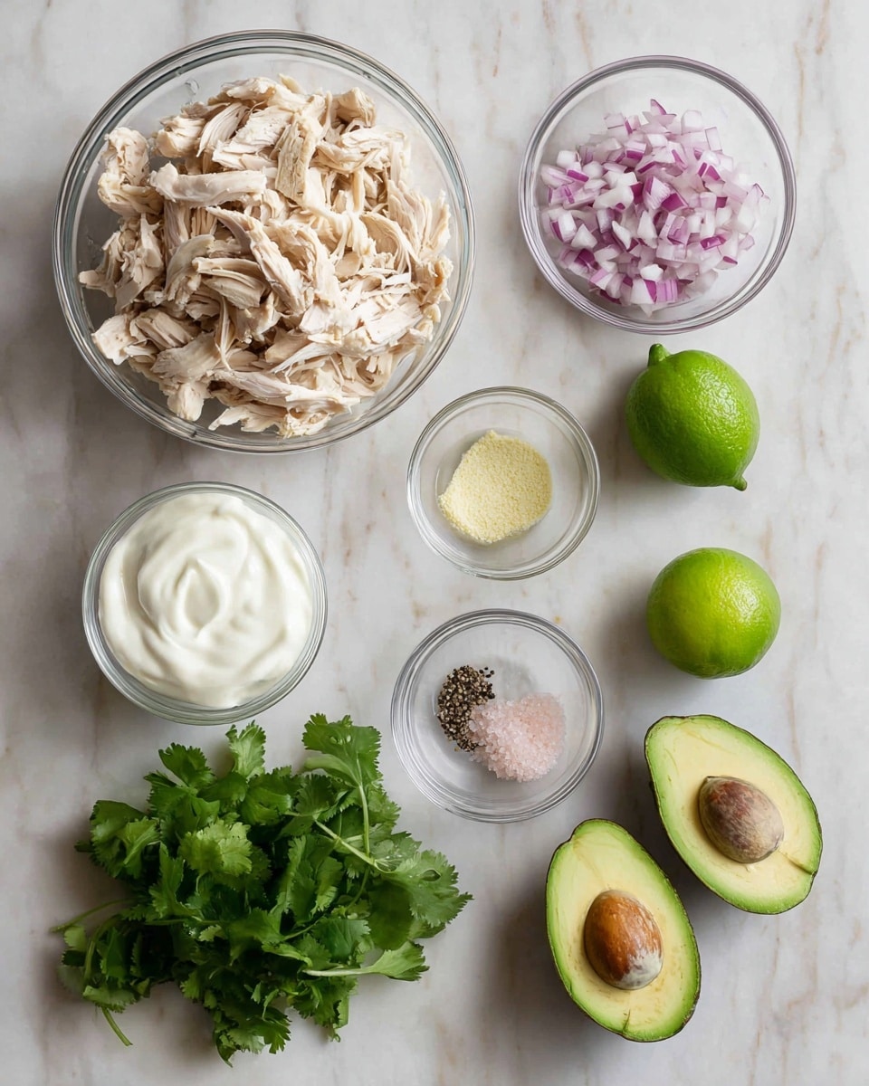 The image shows seven bowls and pieces of food placed on a white marbled surface. The largest bowl on the top left holds a large amount of shredded light beige chicken. To the right, a small glass bowl contains finely chopped red and white onions. Below it are two tiny glass bowls; one has a pale yellow powder and the other contains black pepper and pink salt. In the bottom left of the image, a small glass bowl is filled with smooth white sour cream or yogurt. Fresh green cilantro leaves lie near the center-left. At the bottom right, there are three green avocados, each cut in half showing their creamy green interior and dark brown pits. Above the avocados are two green lime halves showing their juicy interior. The picture has soft natural light and is photo taken with an iphone --ar 4:5 --v 7
