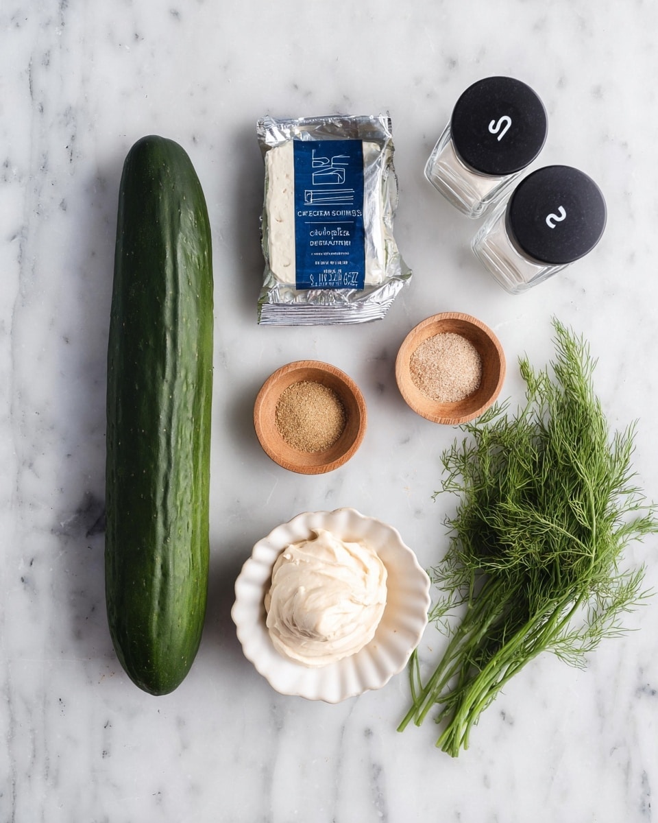 The image shows fresh ingredients laid out on a white marbled surface. There is a long, dark green cucumber on the left side. Next to it is a silver package of cream cheese with blue text. Above the cream cheese is a small white bowl with ruffled edges holding a dollop of light beige mayonnaise. Two small wooden bowls contain light brown powder spices. A small bunch of fresh green dill rests on the right side. At the top, there are two clear shakers with black tops marked with “S” for salt and “P” for pepper. The arrangement is clean and simple. photo taken with an iphone --ar 4:5 --v 7