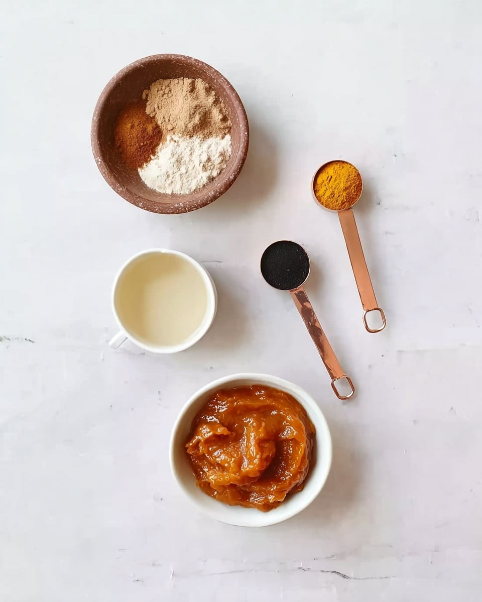 The image shows a flat lay of five kitchen items on a white marbled surface. At the bottom center is a white bowl filled with a thick, orange-colored paste. Above it and slightly to the left is a small white cup filled with a pale liquid. To the left and above the cup is a brown clay bowl holding a mix of white, brown, and tan powders. Above and between these bowls are two measuring spoons; one is copper with a yellow powder inside, and the other is silver with a black powder inside. The arrangement is neat and evenly spaced. photo taken with an iphone --ar 4:5 --v 7