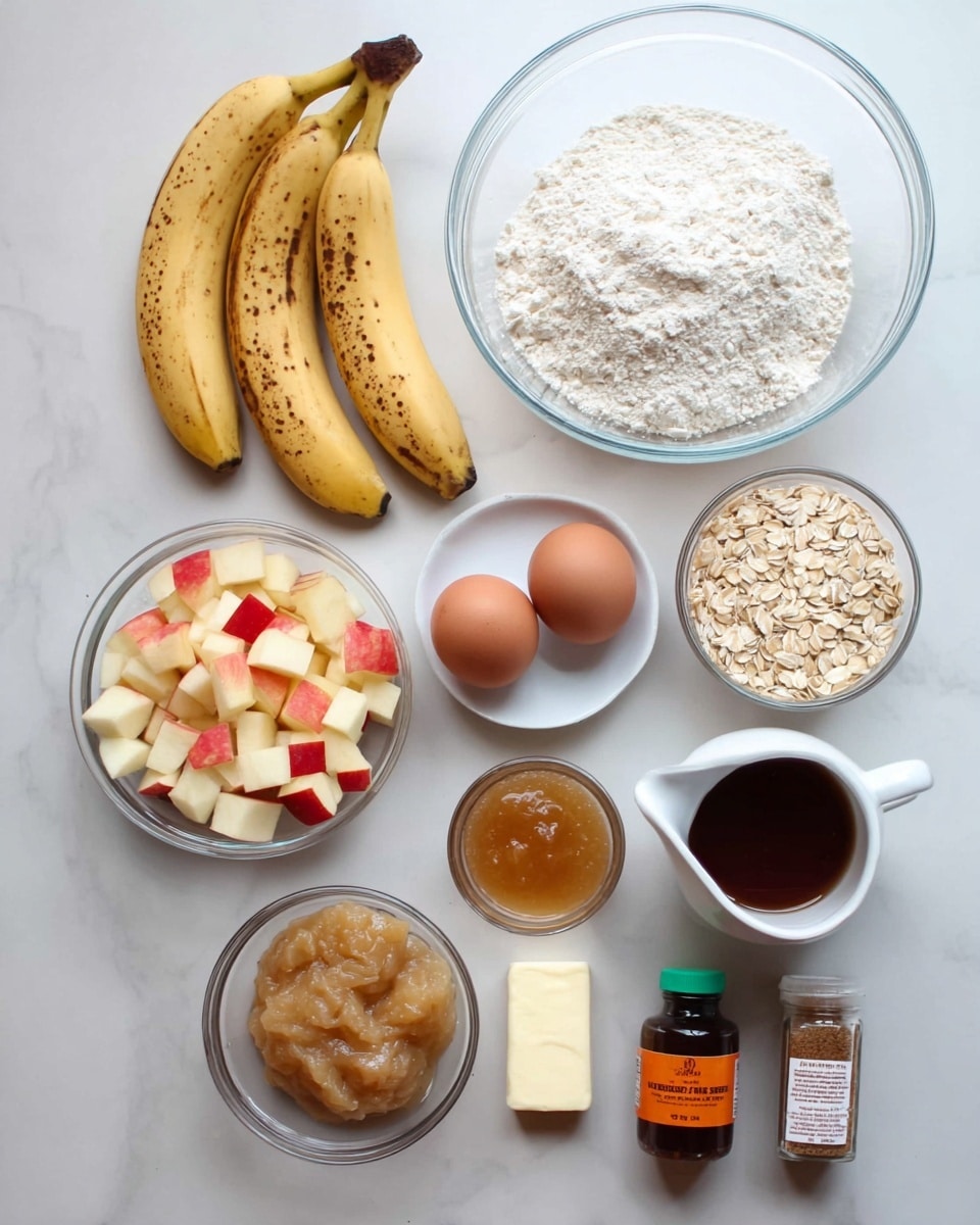The image shows a top view of arranged ingredients for baking on a white marbled surface. There are two ripe bananas with brown spots placed side by side on the left. Above them is a large clear glass bowl filled with white flour. Next to the bowl, on the right side, there is a clear glass bowl with light brown rolled oats. Below the oats and flour bowls, there is a small white plate with two brown eggs resting on it. Below the eggs, there is a clear glass bowl filled with small cubes of red apple with white flesh. Next to it on the left is a clear glass bowl with light beige applesauce. To the right of the diced apples is a small white pitcher filled with a dark amber syrup. Below these bowls are three small containers: a small stick of butter in wrapper, a dark brown bottle with an orange label, and a clear jar with a green lid containing ground cinnamon. The whole scene is lit softly, showing clean and simple colors. Photo taken with an iphone --ar 4:5 --v 7