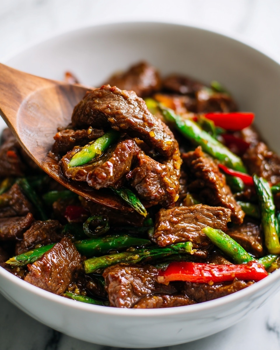 The image shows a close-up of a stir-fry dish in a white bowl, filled with rich brown cooked beef slices that are shiny and moist, mixed with bright green and red bell pepper strips scattered evenly around the beef pieces. A wooden spatula is lifting some of the beef and green pepper, showing the tender texture of the beef and the glossy sauce coating everything. The background surface is a white marbled texture, adding brightness to the image. photo taken with an iphone --ar 4:5 --v 7